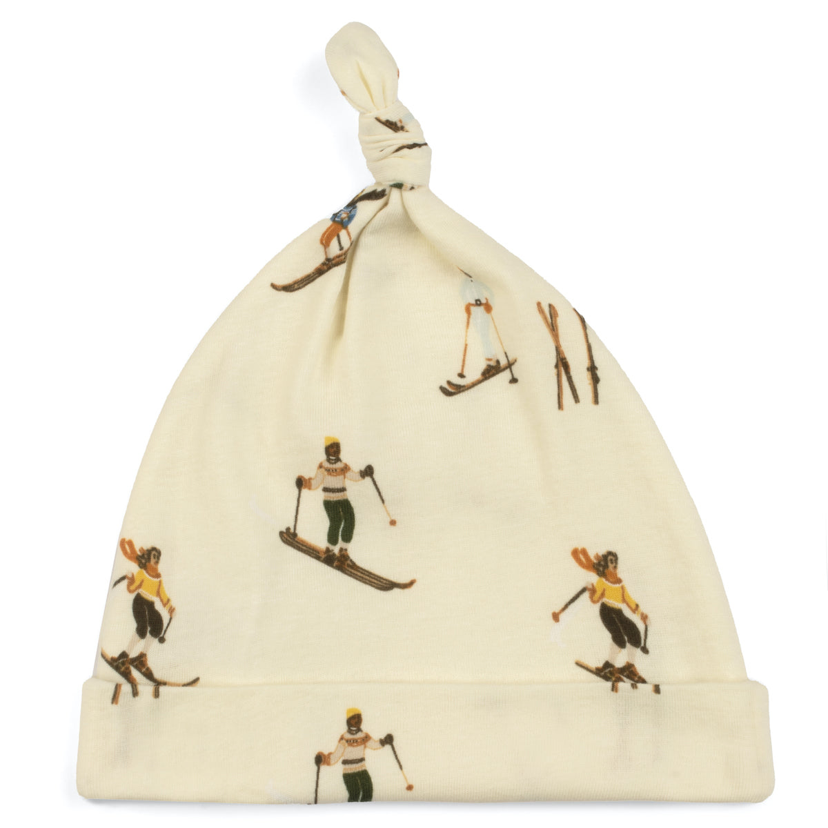 A beige organic cotton knotted baby hat with a vintage ski print, including illustrations of skiers and ski equipment.