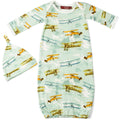 A newborn gown and hat set with a vintage airplane pattern on a green background, featuring a knot on the hat.