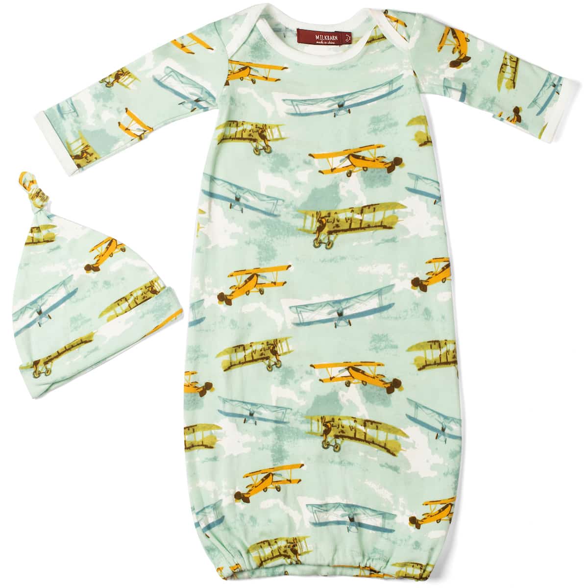 A newborn gown and hat set with a vintage airplane pattern on a green background, featuring a knot on the hat.