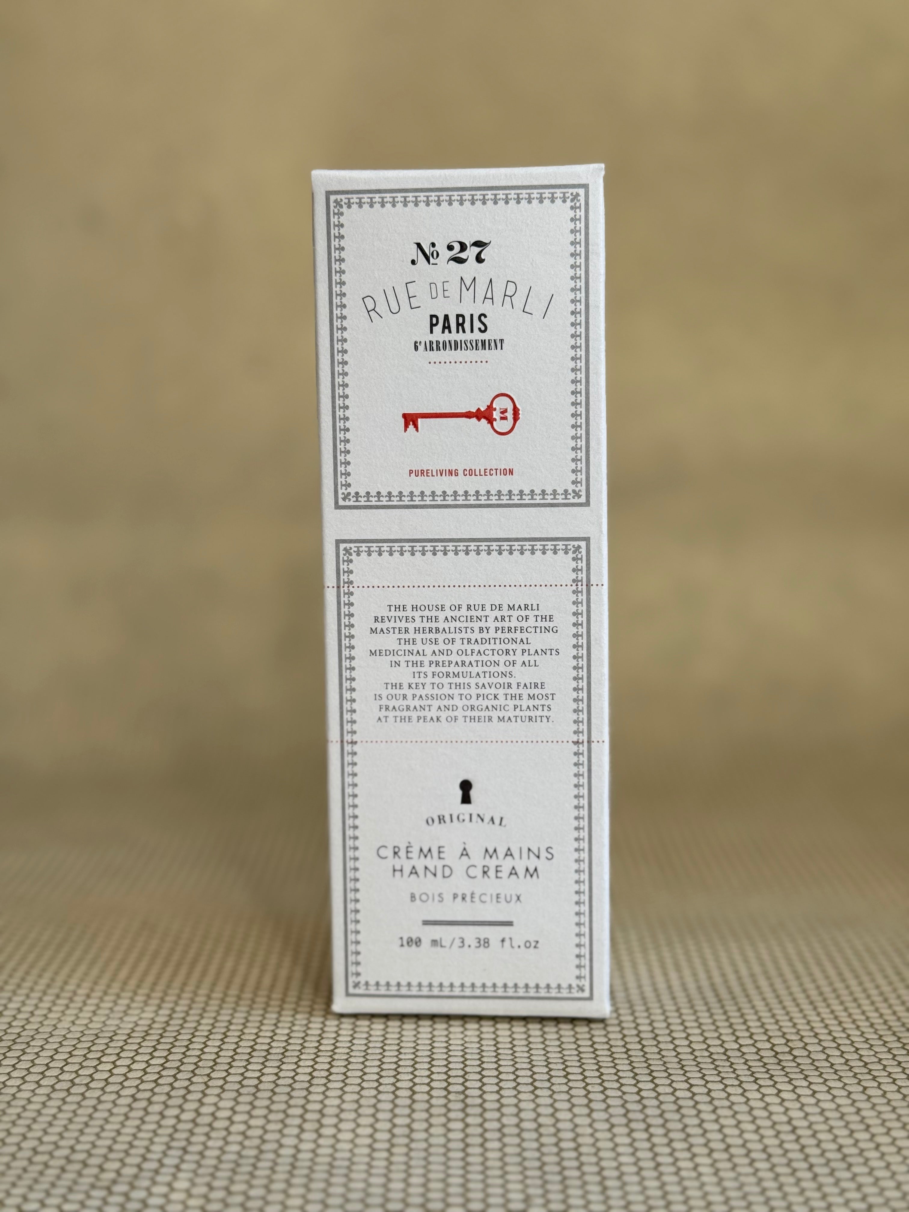 White box rue de marli hand cream on a beige background