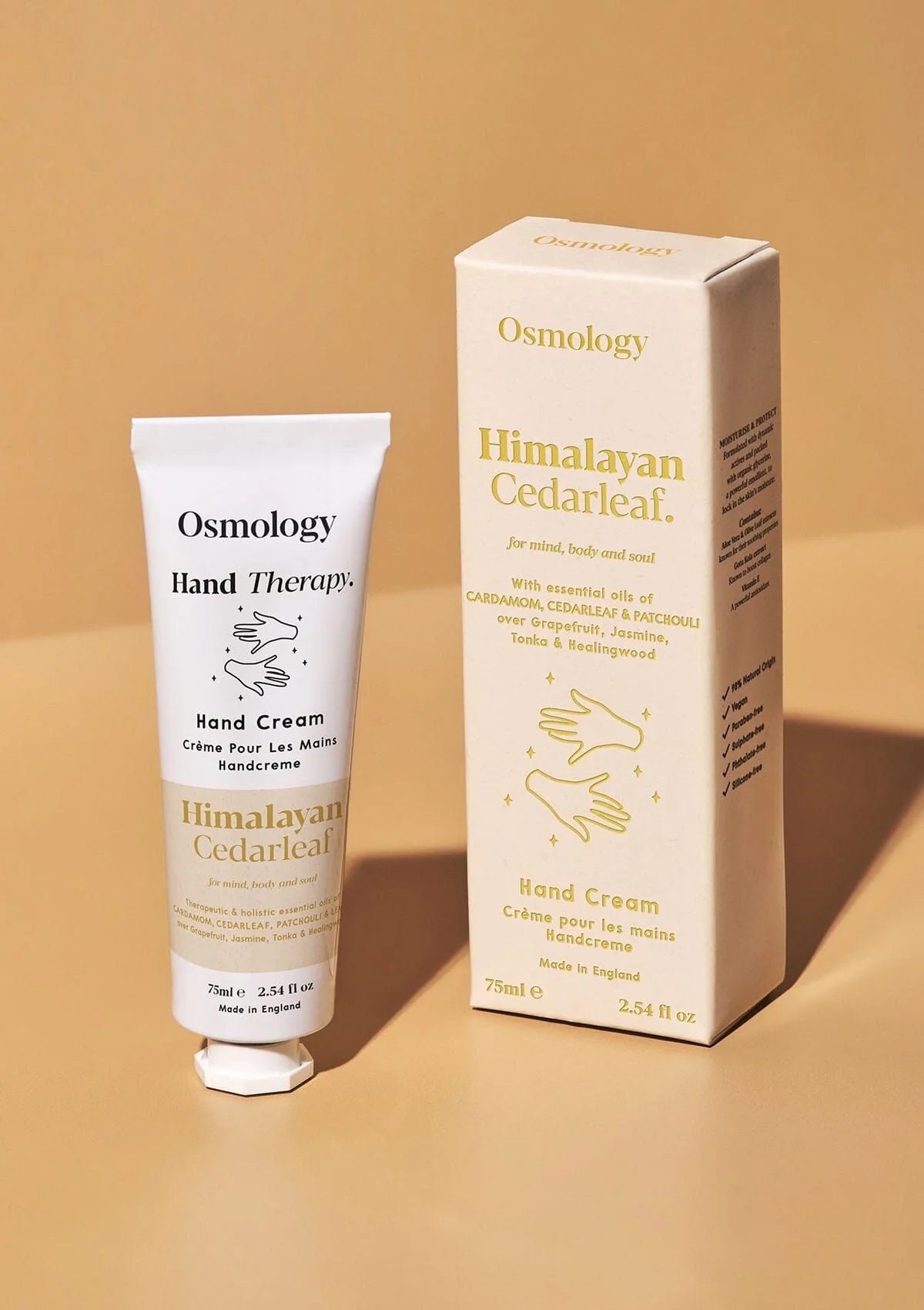 Osmology Himalayan Cedarleaf hand cream and packaging on a beige background