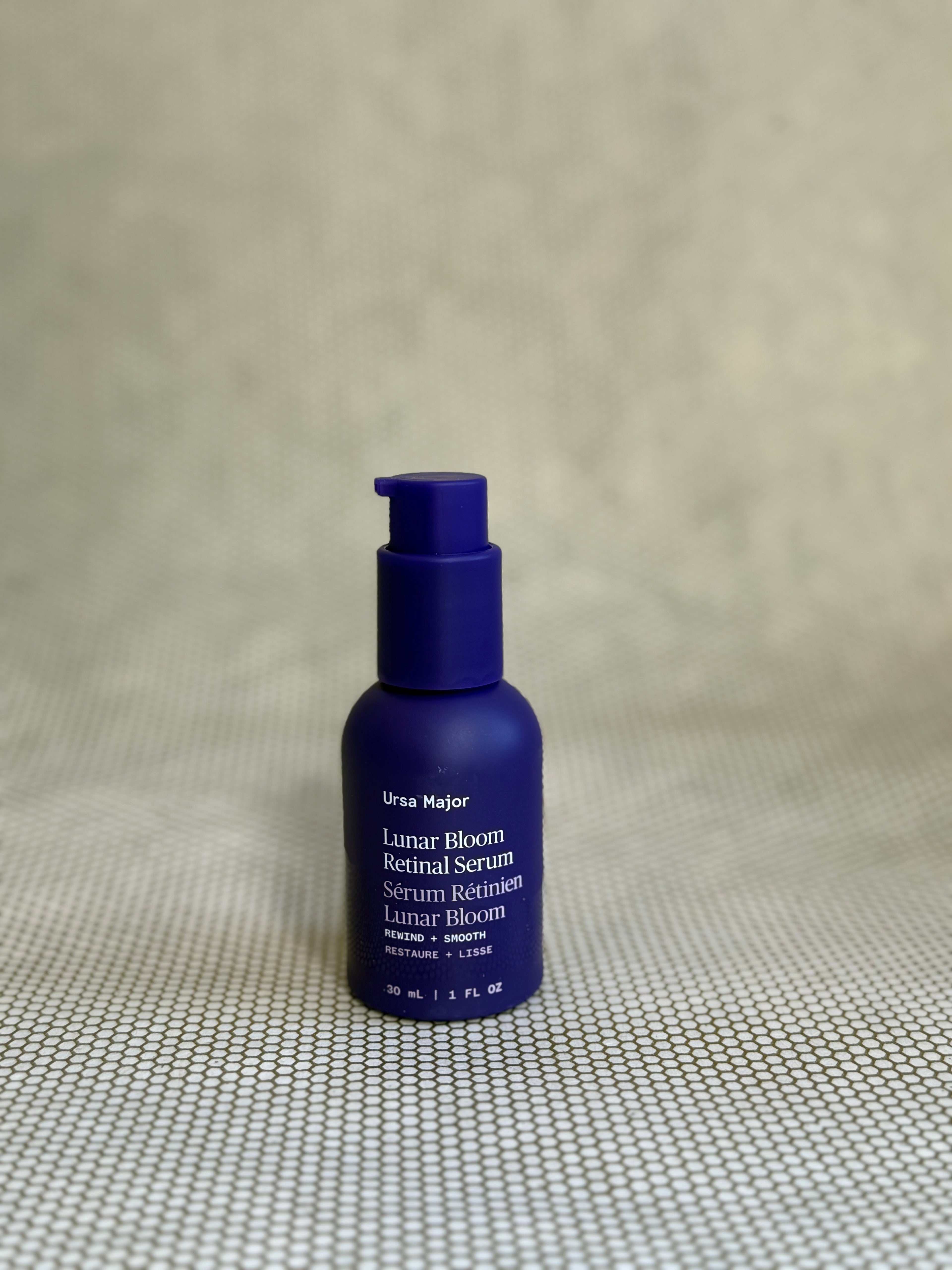 dark blue pump bottle of Ursa Major Lunar Bloom Retinal Serum.