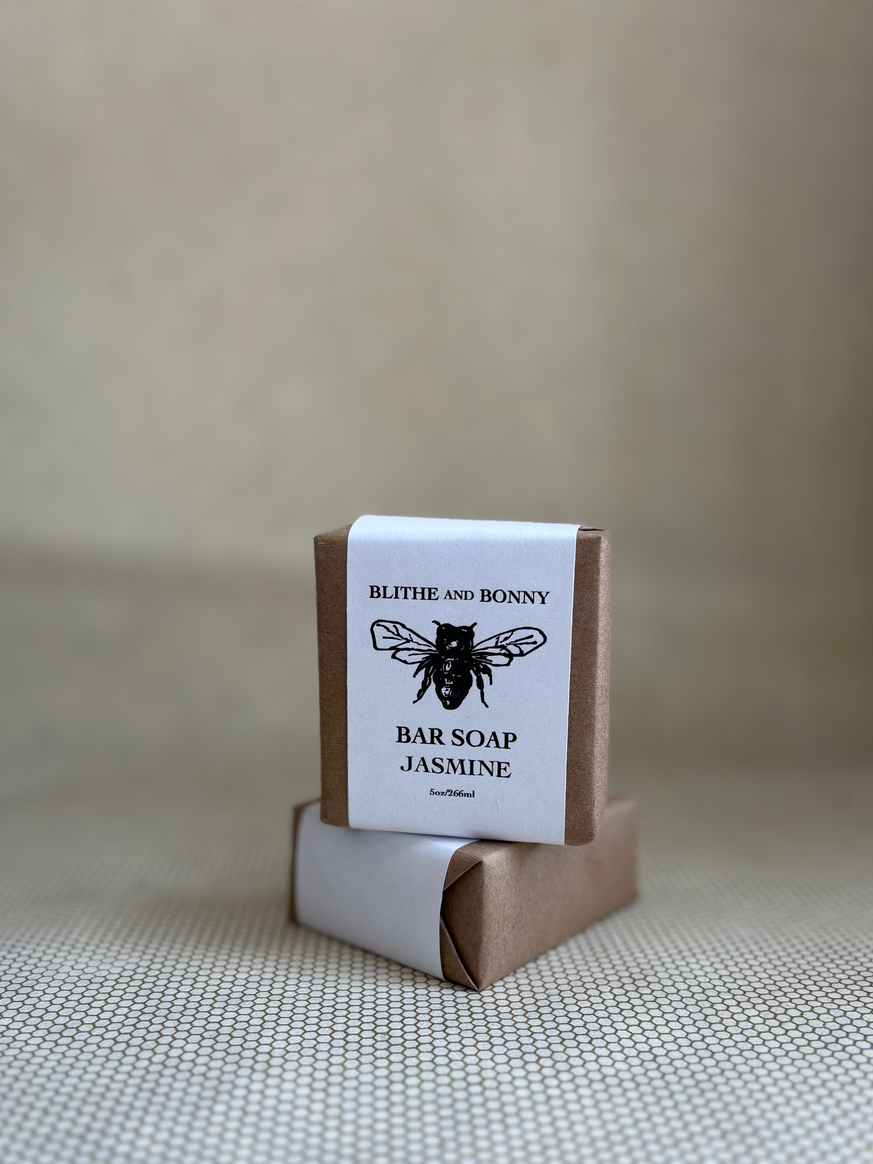 Bar of soap with a brown and white paper label cigar wrap. bumblebee graphic. vegan soap blithe and bonny. 