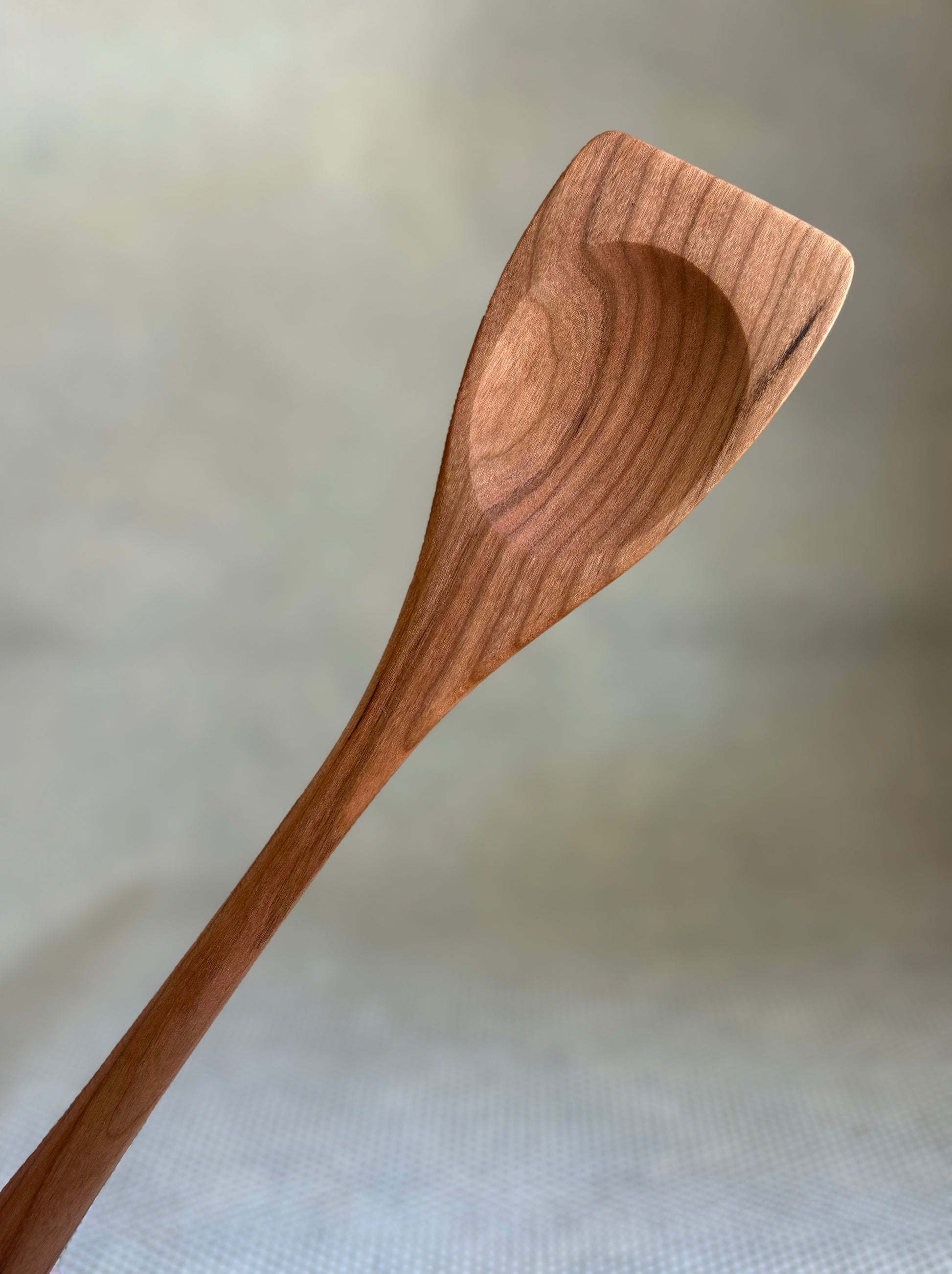 Wooden spoon on a light fabric background