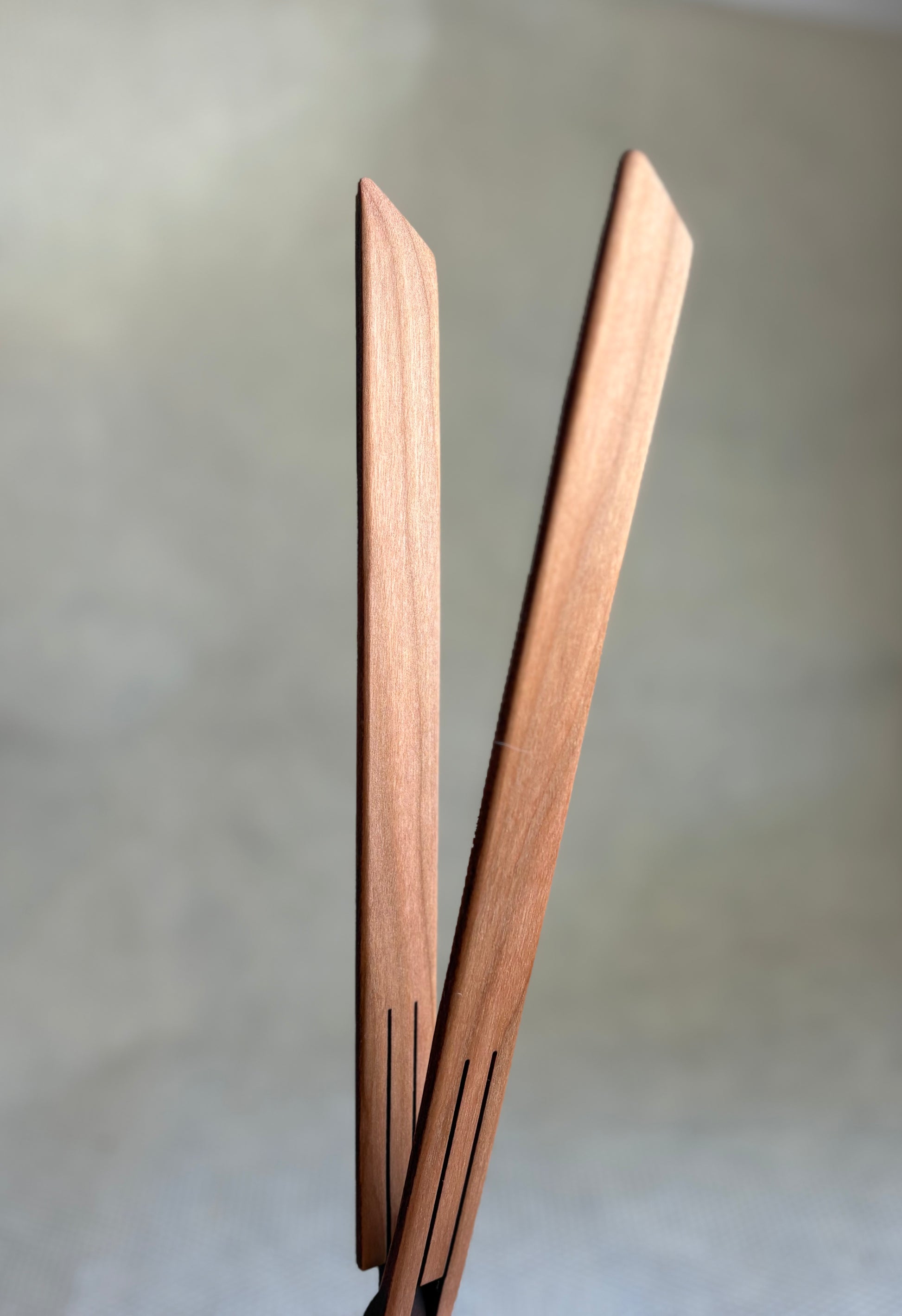wooden inside out tongs for cooking on light neutral background. Jonathan's Spoons. 