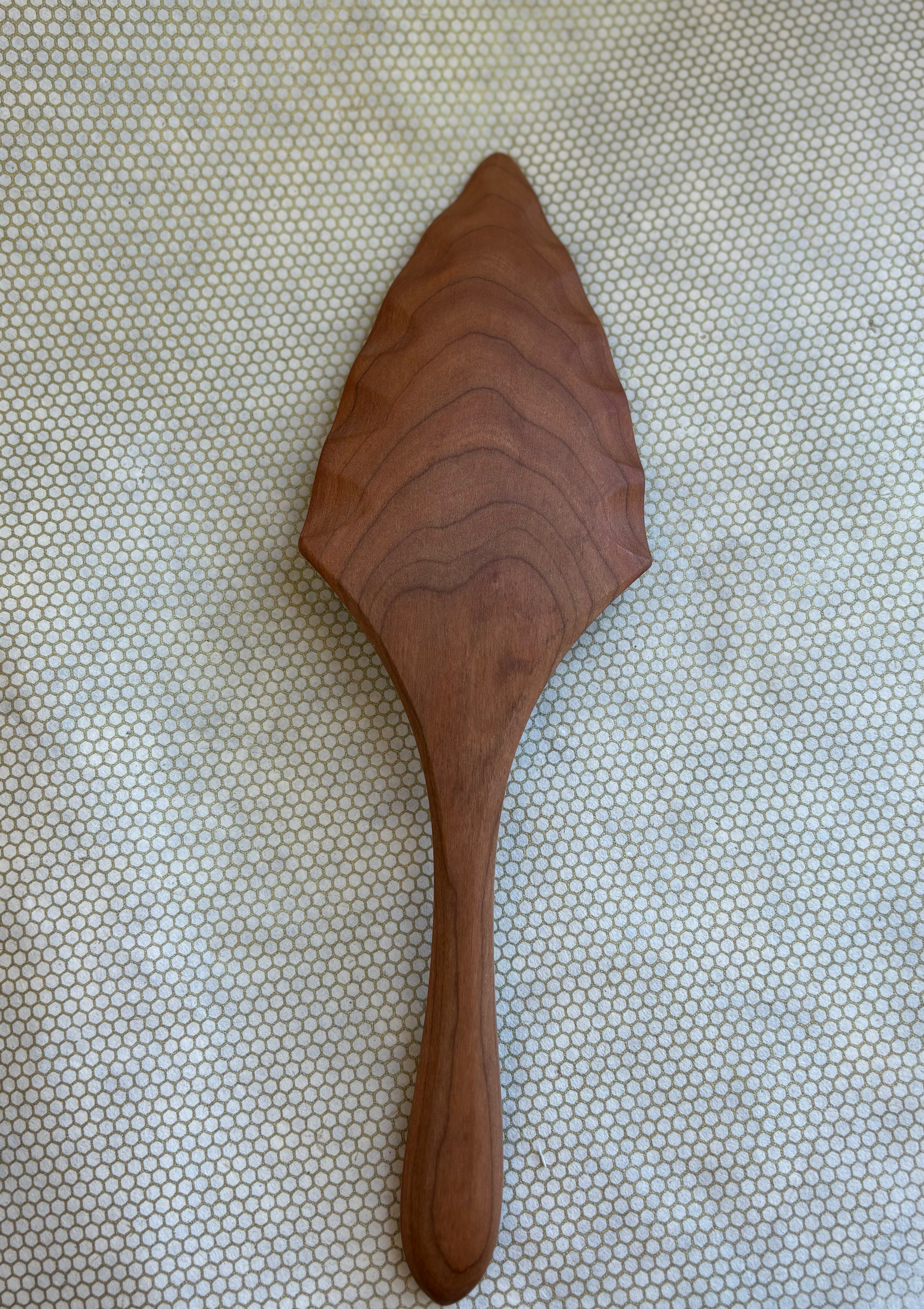 Jonathan's Spoons natural wooden pie server on light natural background. 