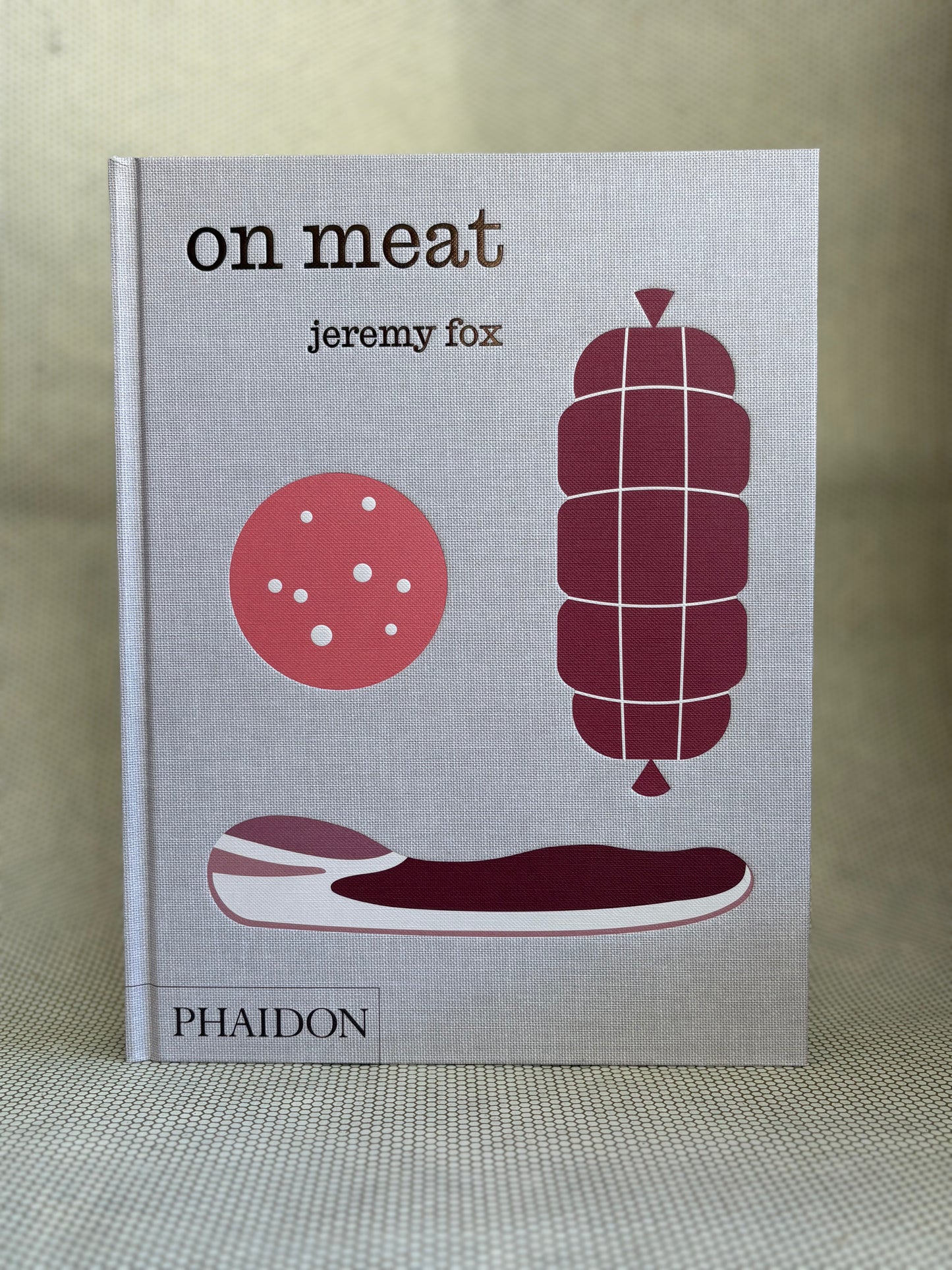 Book titled 'on meat' by Jeremy Fox with illustrations of meat products on a gray background