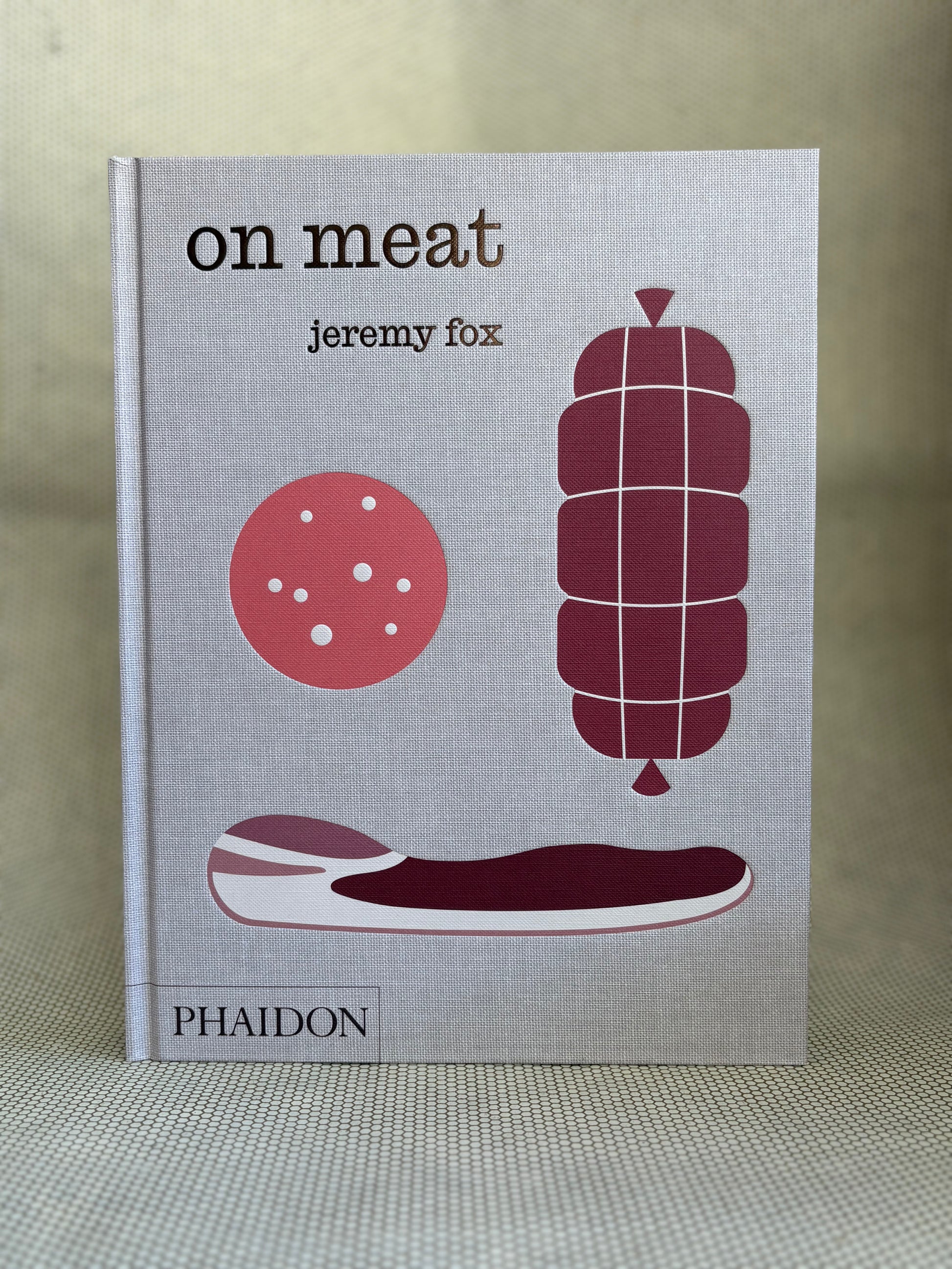 Book titled 'on meat' by Jeremy Fox with illustrations of meat products on a gray background