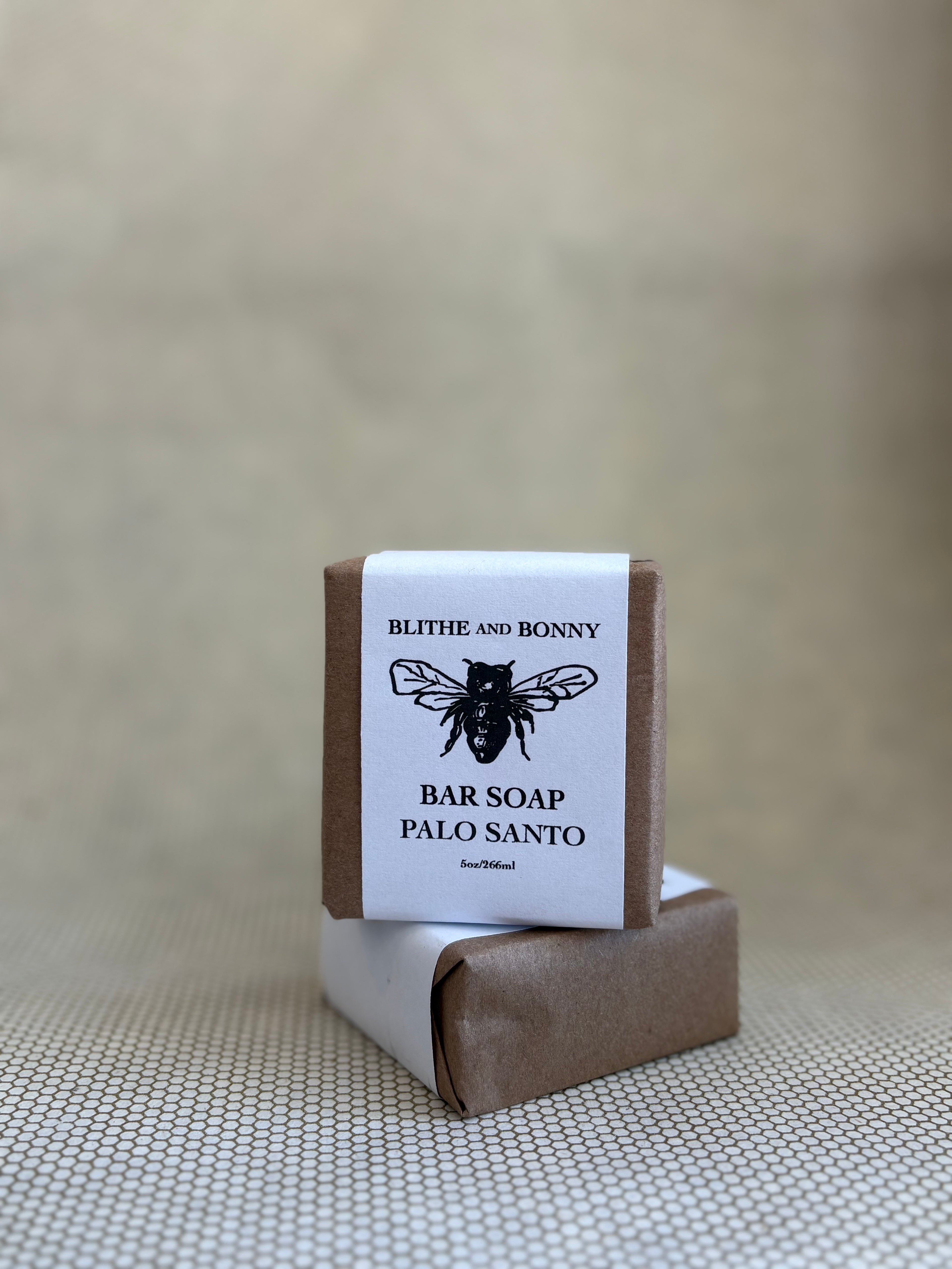 Blithe and Bonny vegan bar soap with a brown and white paper label cigar wrap and bumblebee graphic. 