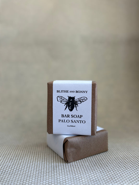 Blithe and Bonny vegan bar soap with a brown and white paper label cigar wrap and bumblebee graphic. 