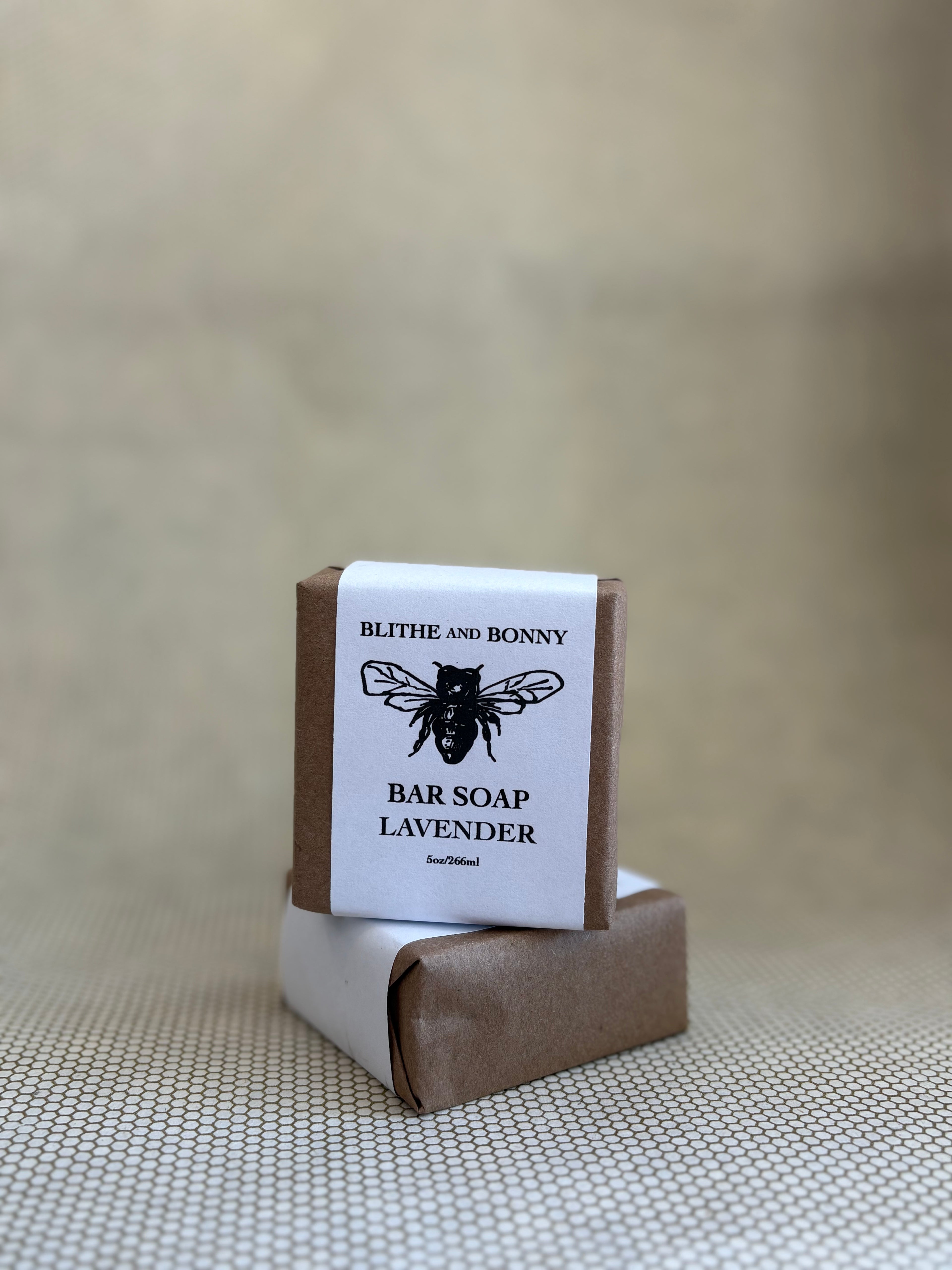 Bar of soap with a brown and white paper label cigar wrap. bumblebee graphic. vegan soap blithe and bonny. 