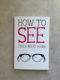 Book cover of 'How to See' by Thich Nhat Hanh with a pair of glasses illustration on a textured background.