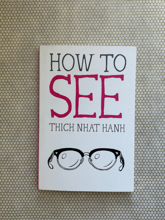 Book cover of 'How to See' by Thich Nhat Hanh with a pair of glasses illustration on a textured background.