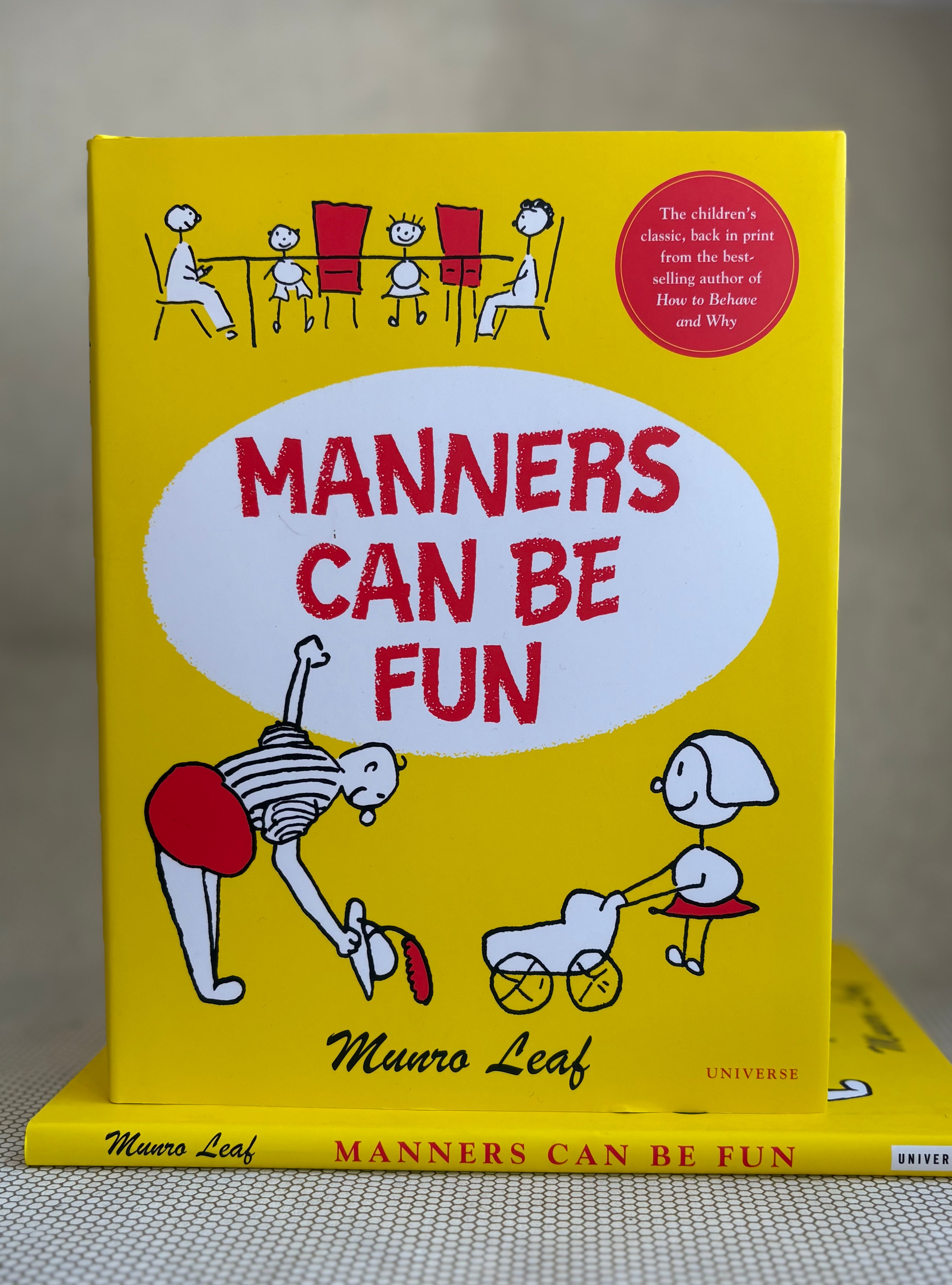 Book titled 'Manners Can Be Fun' by Munro Leaf with cartoon illustrations on a yellow background.