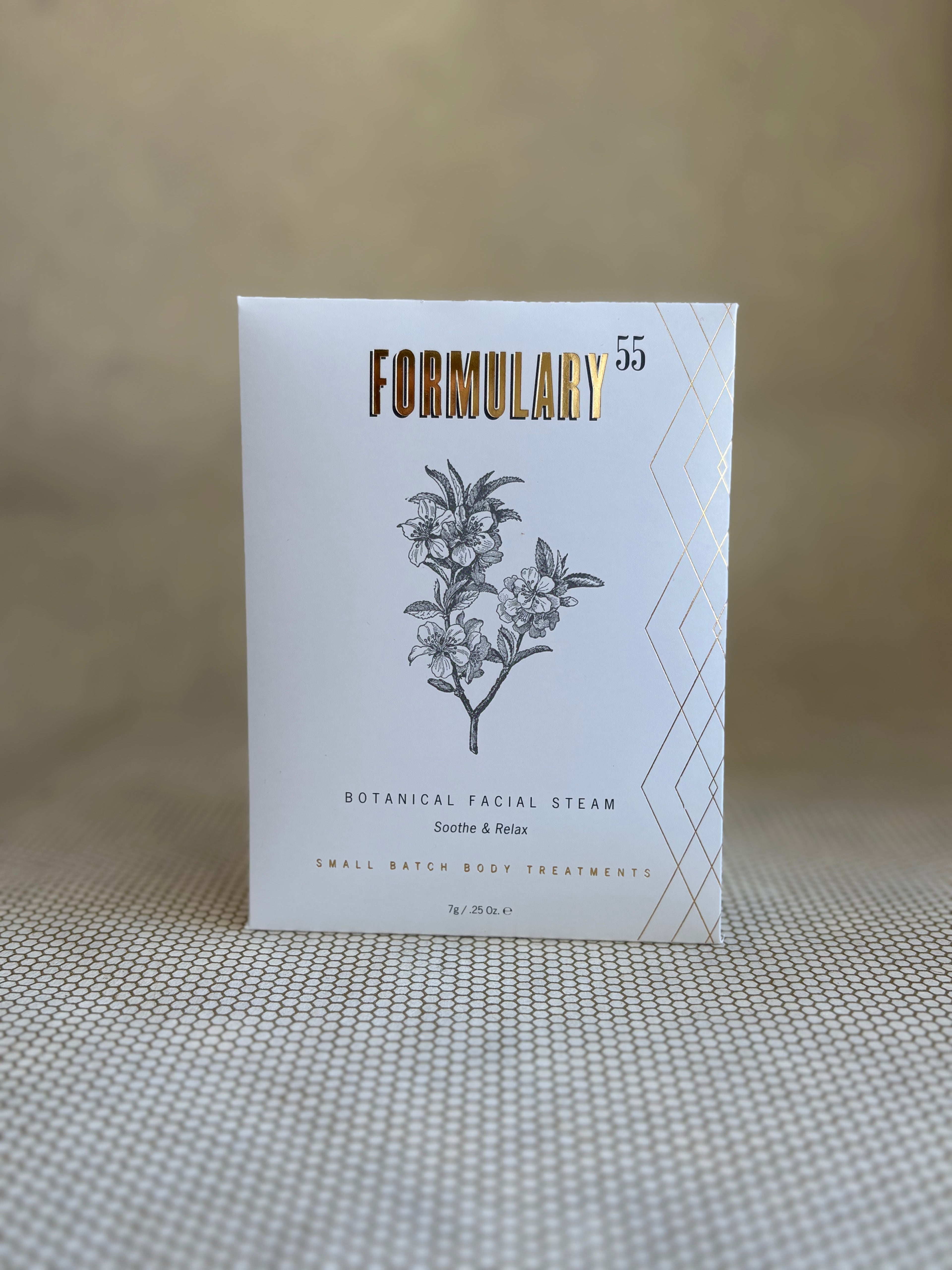 Formulary 55 botanical facial steam packaging on a textured surface with a neutral background