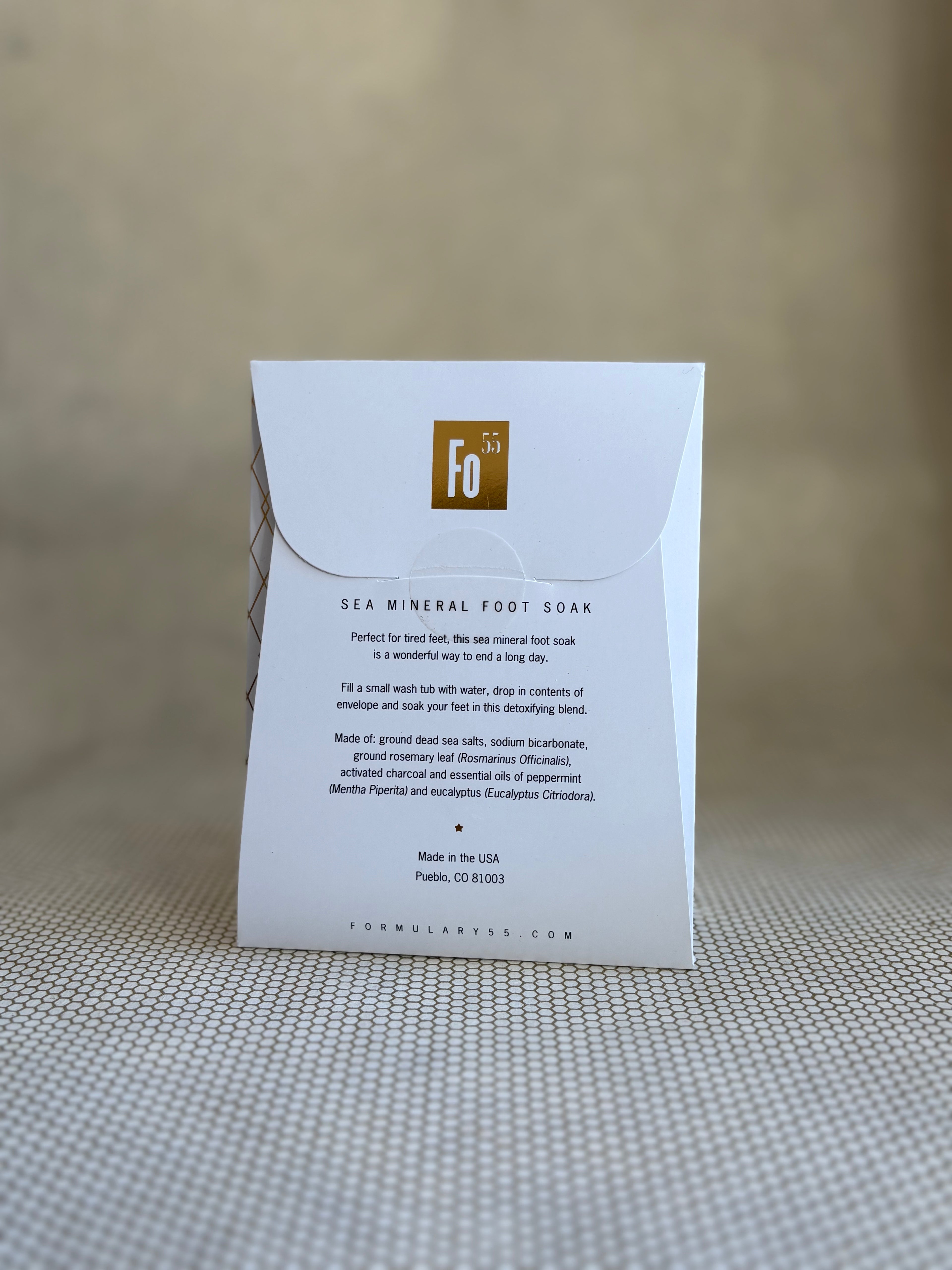 back of Formulary 55 eucalyptus and peppermint Sea Mineral foot soak in white packaging with black floral graphic. 