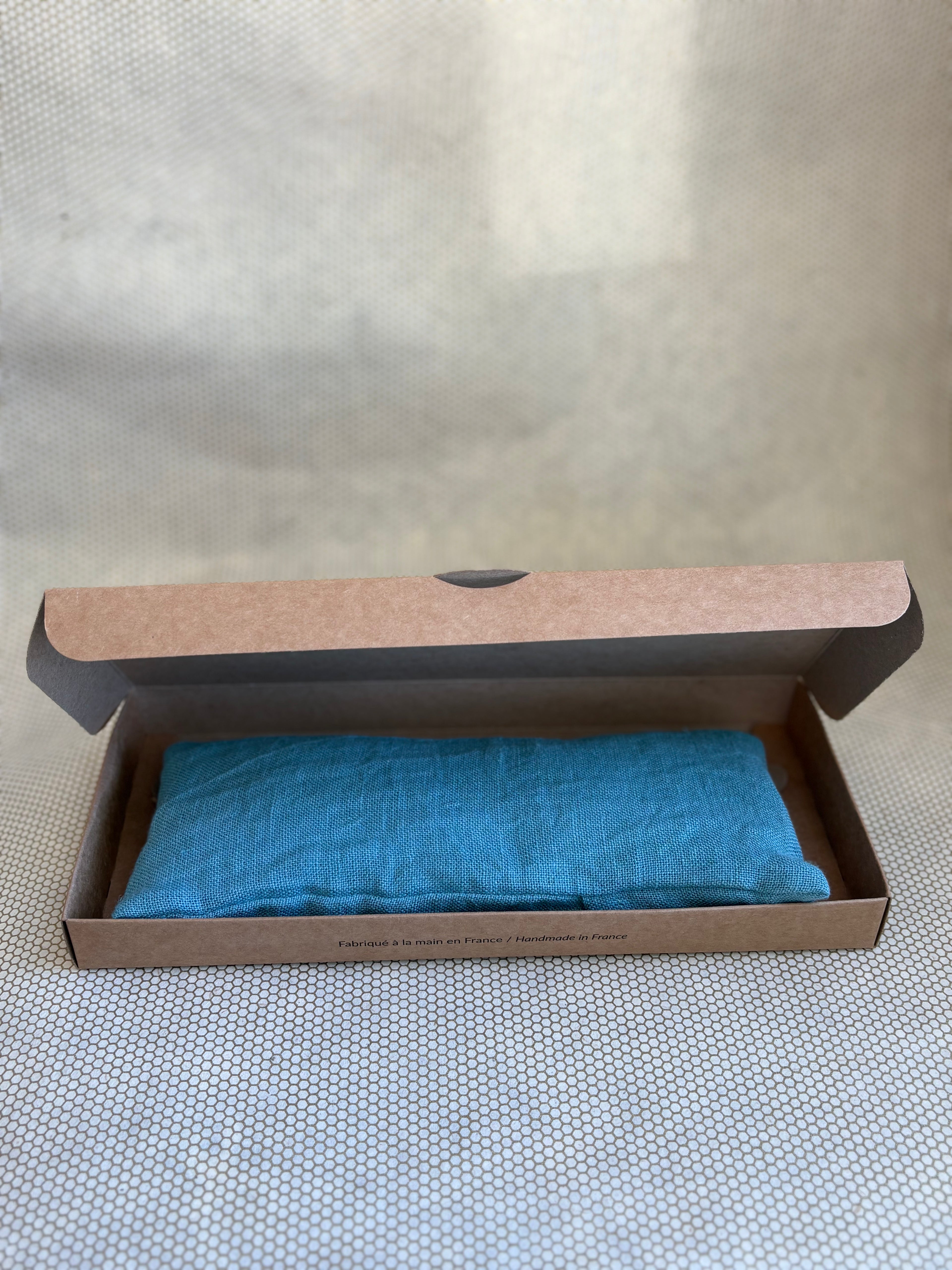 blue eye pillow in a brown cardboard box 