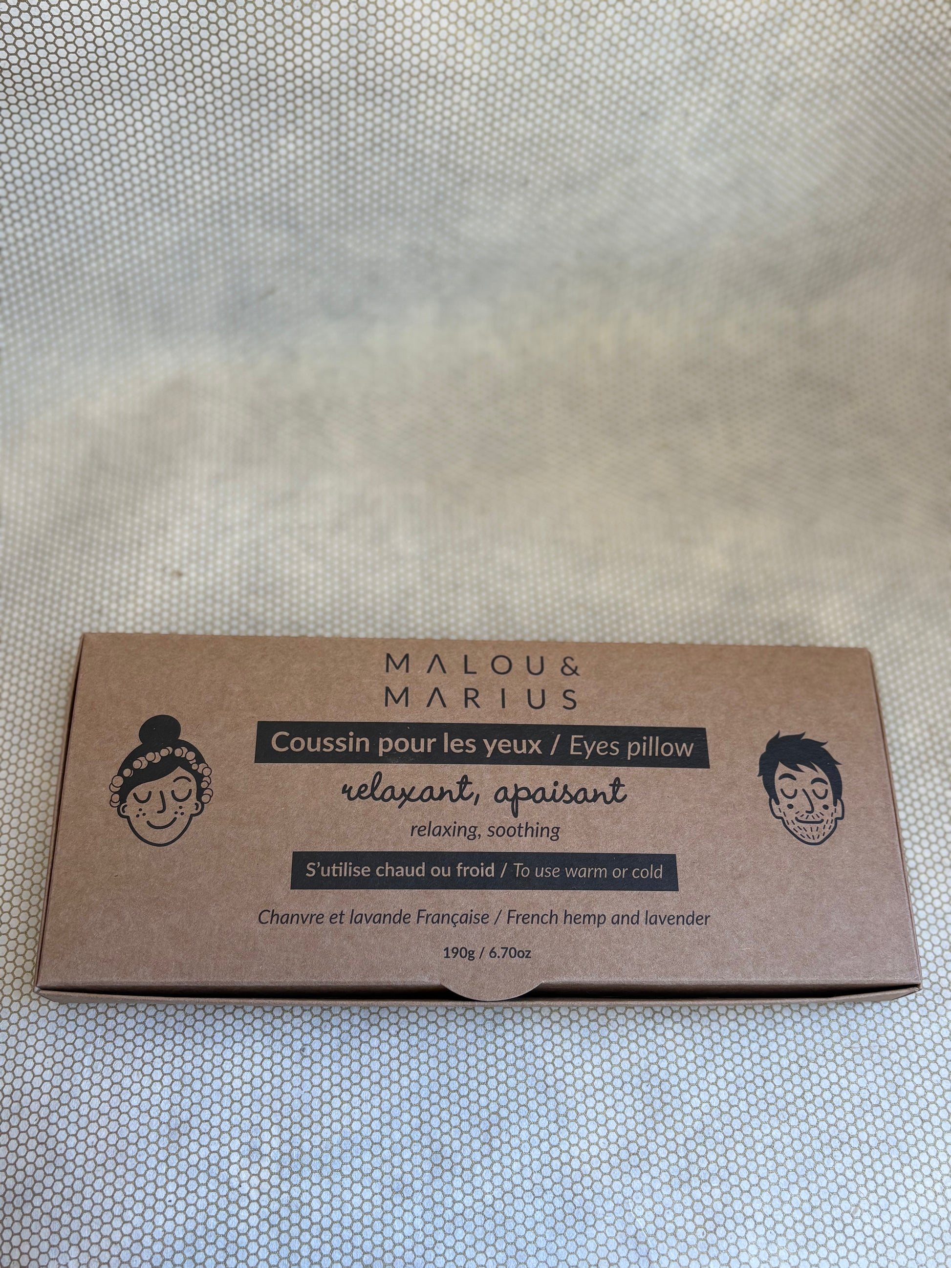 Malou & Marius eyes pillow packaging on a textured surface