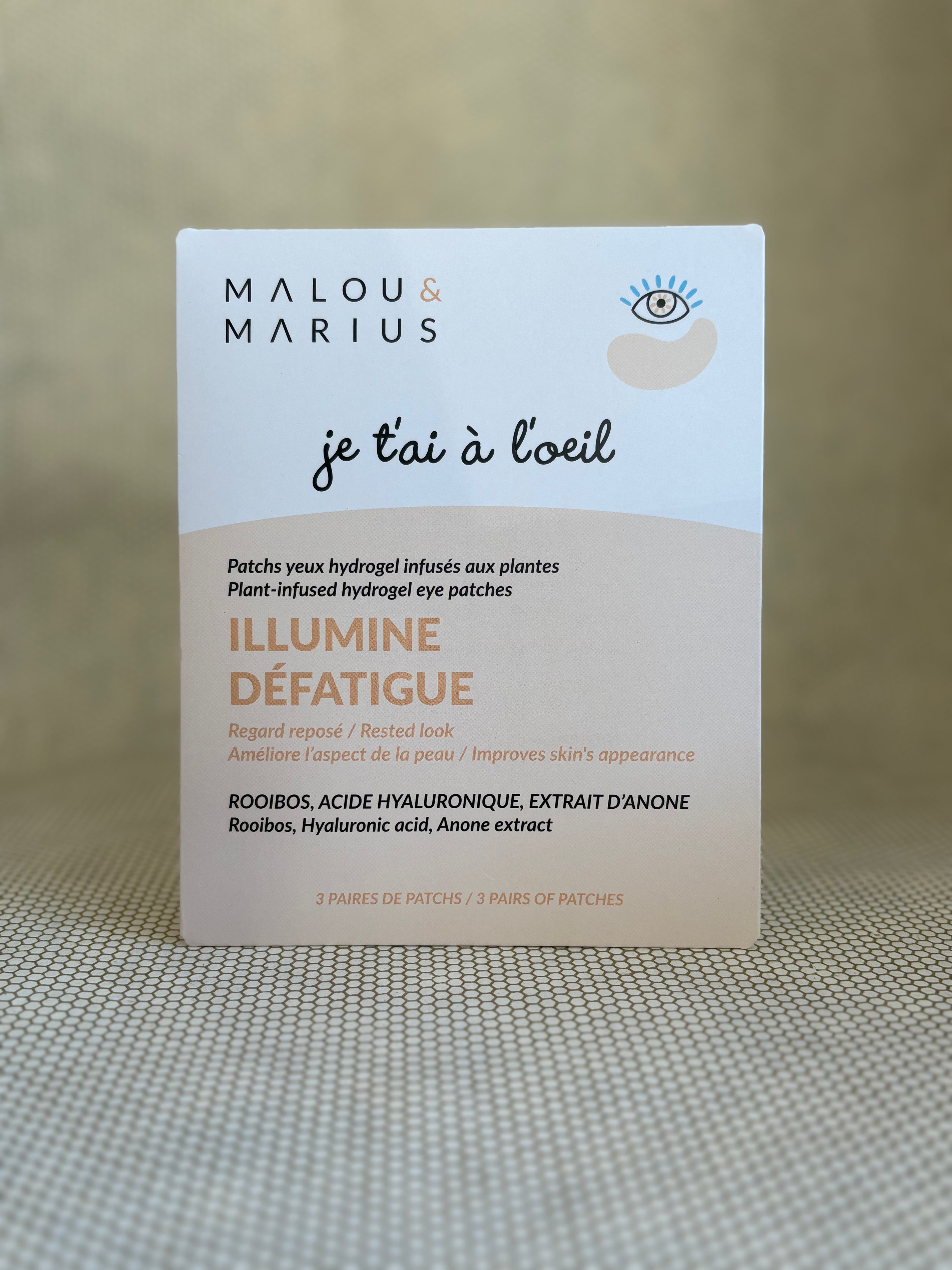 peach and white packaging of Malou & Marius eye patches on a textured surface