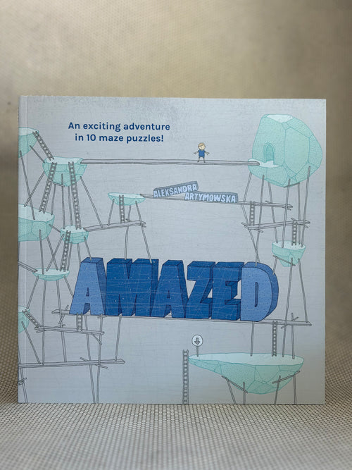 Book titled 'Amazed' with maze puzzles on a textured surface