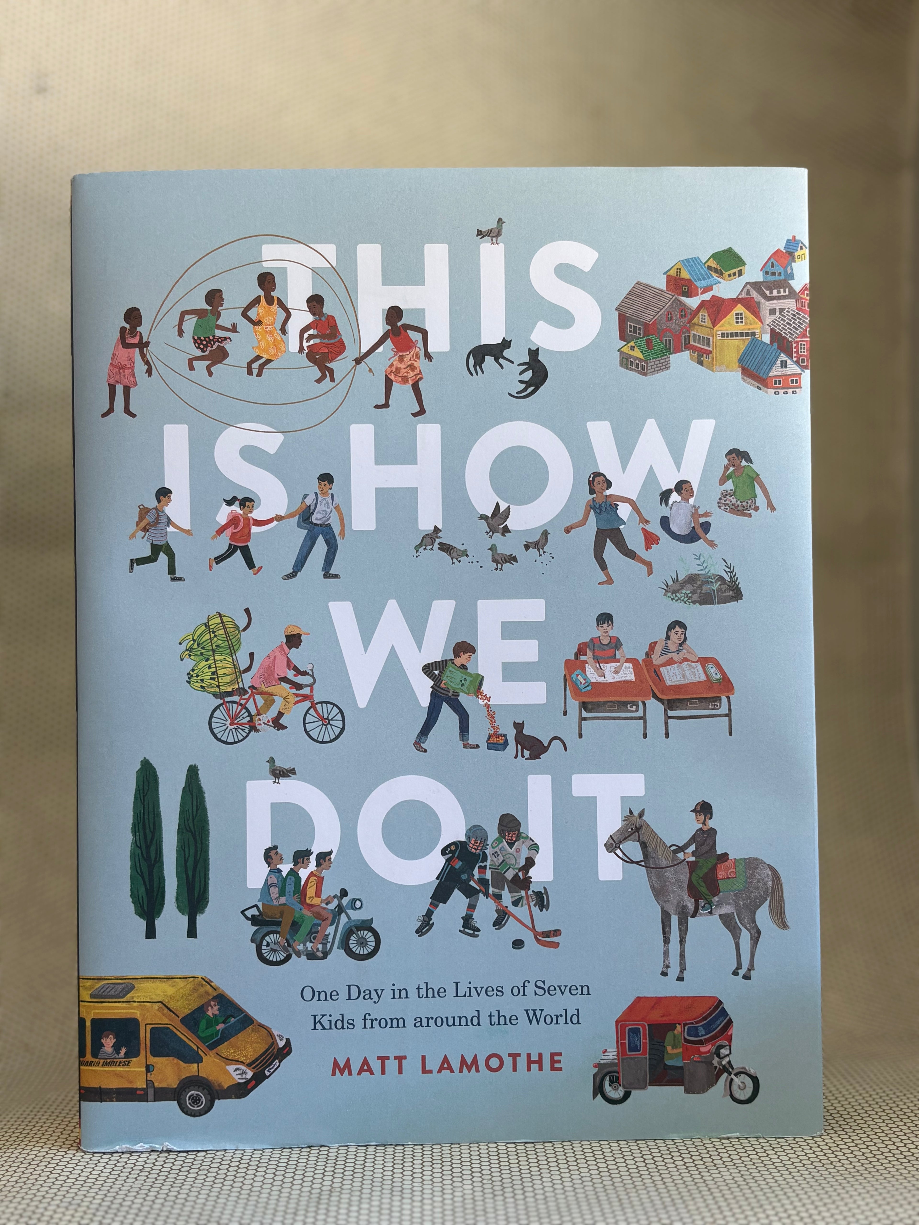 Book cover with illustrations of children and text "this is how we do it"on a beige background.