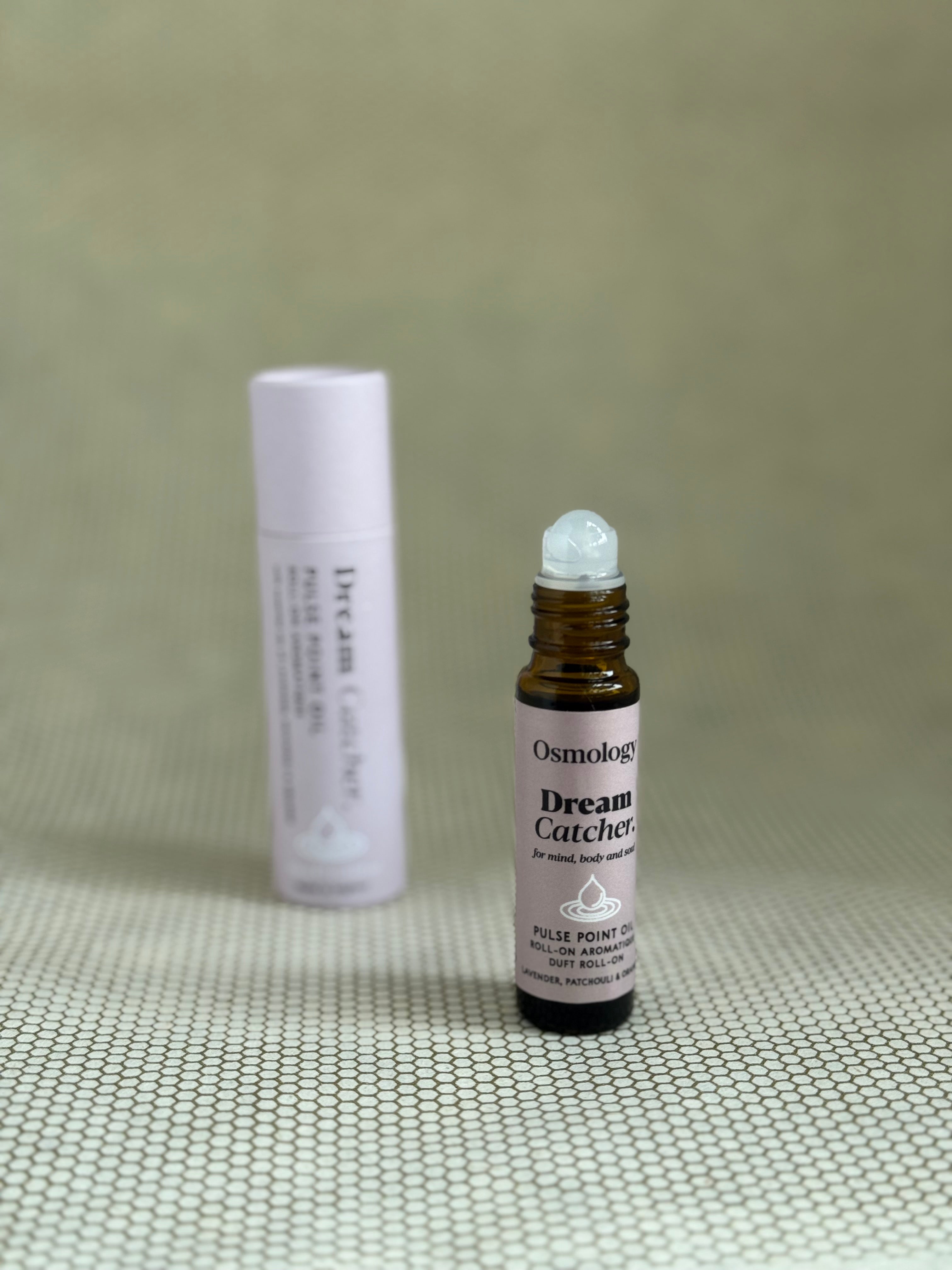 Osmology Dream Catcher pulse point roll-on aromatherapy oil with baby pink packaging. 