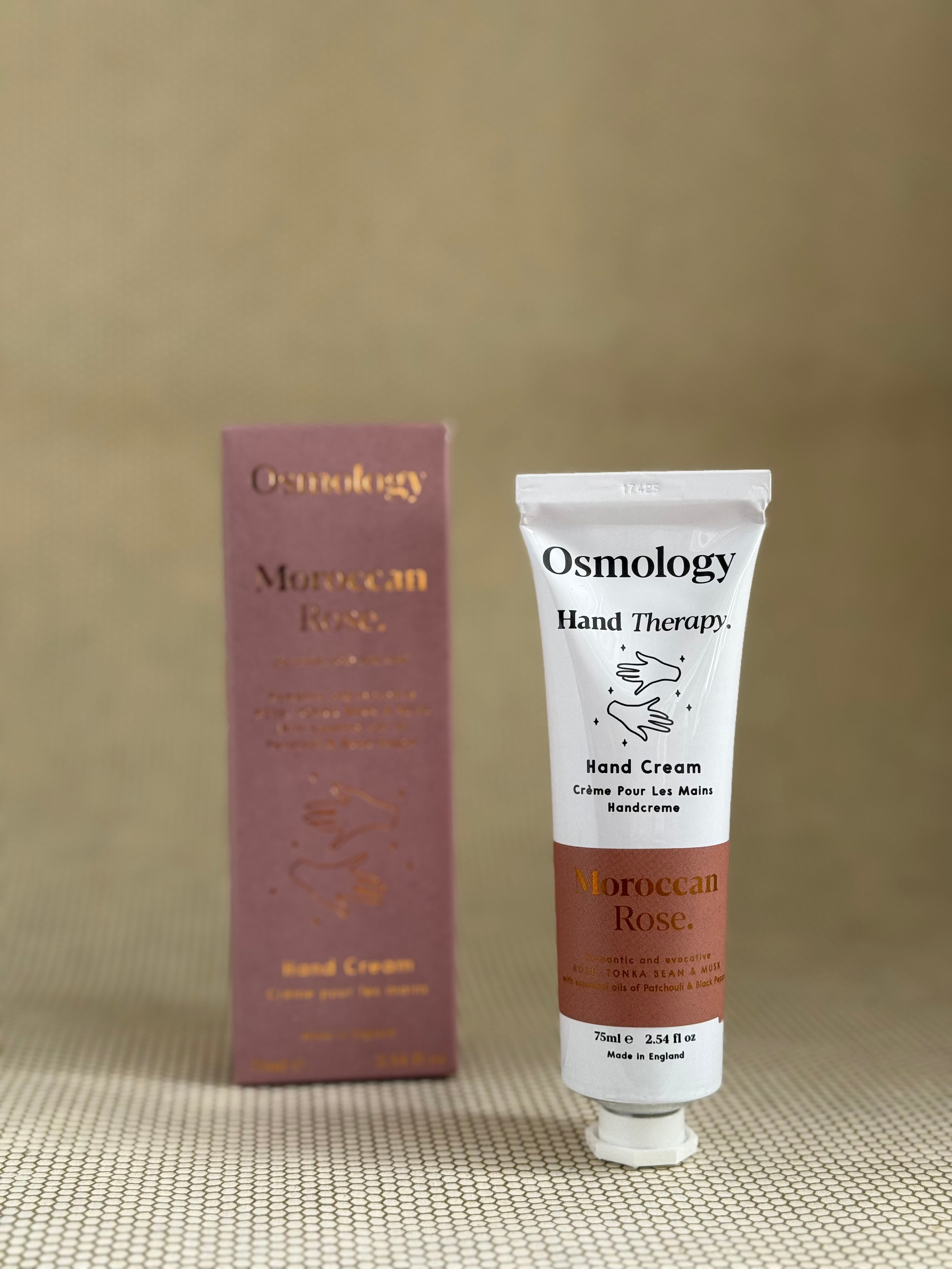 Osmology Moroccan Rose hand cream tube and packaging on a beige background