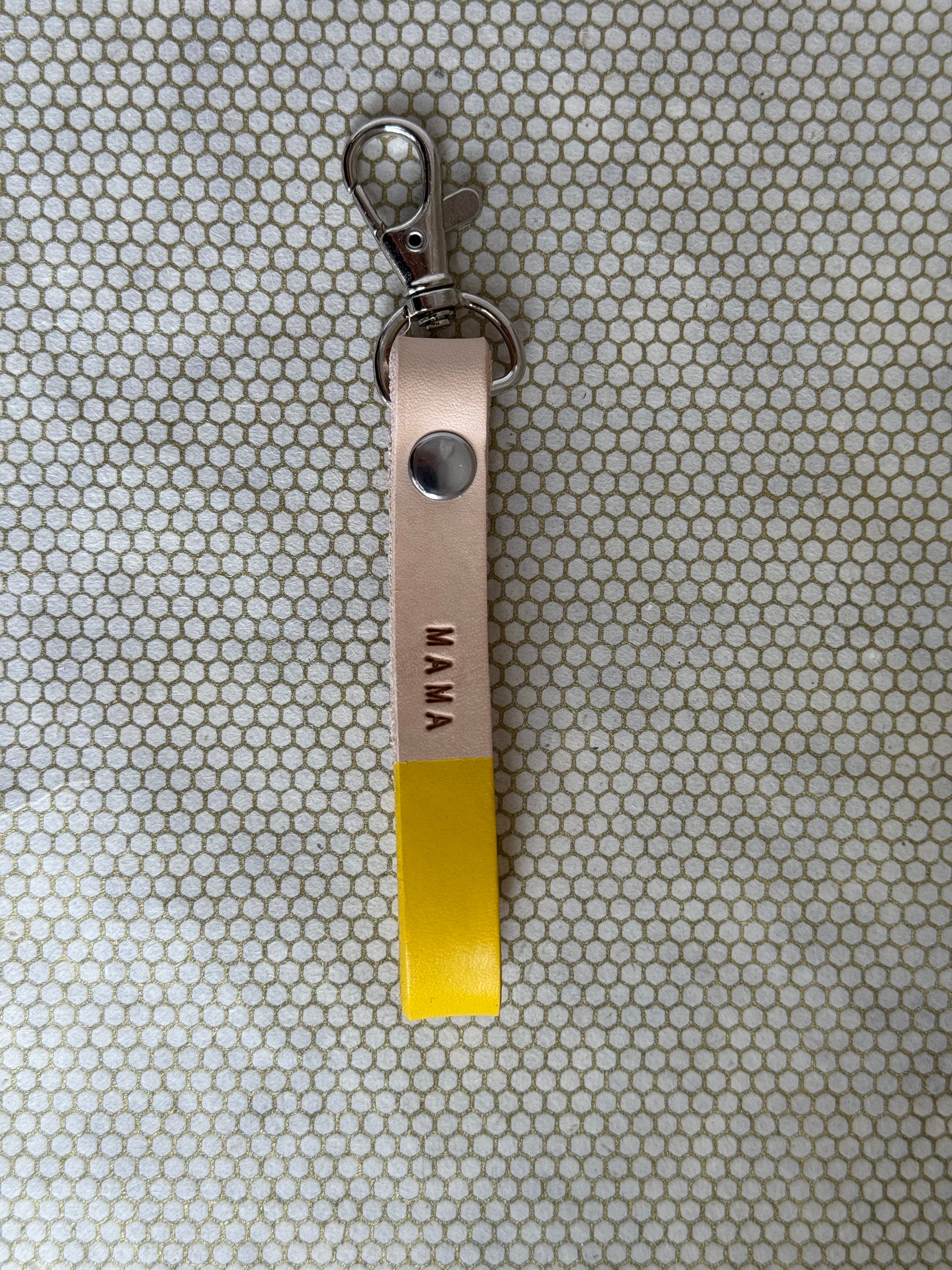 yellow color keychains with leather straps and "mama" lettering on leather. 