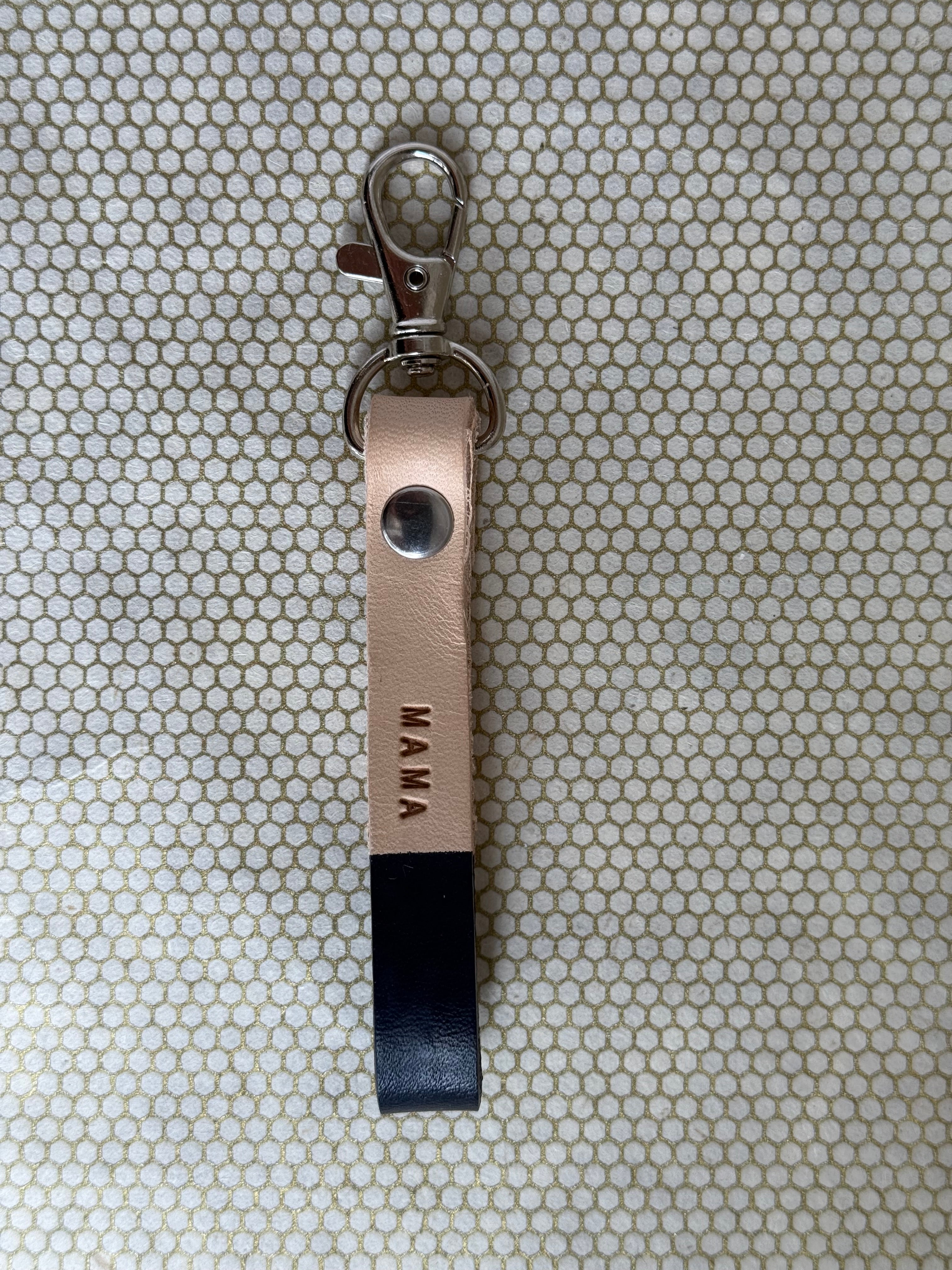 black color keychains with leather straps and "mama" lettering on leather. 