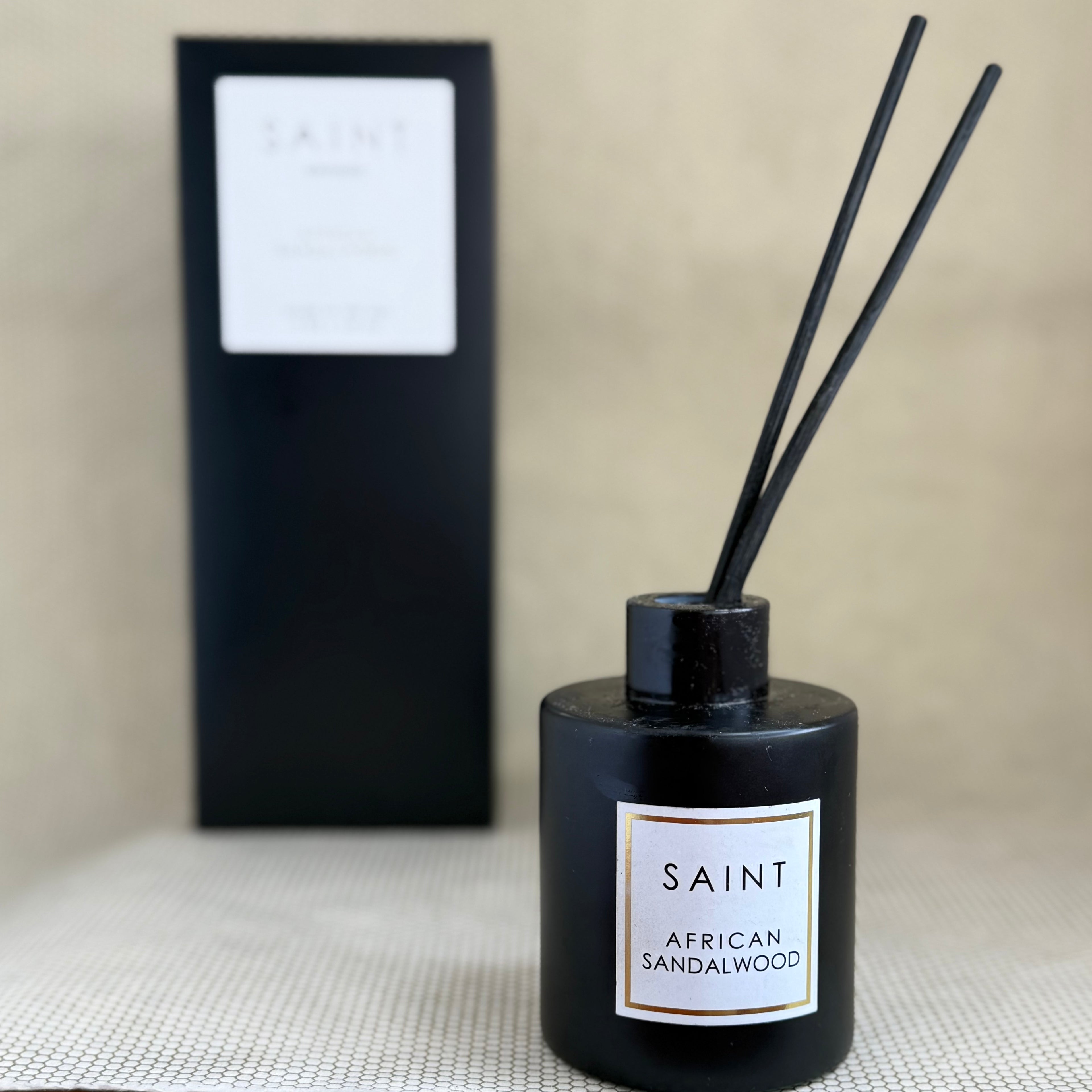 black reed diffuser bottle and black box. black diffuser wooden reed sticks. SAINT. african sandalwood. 5oz (145mL)