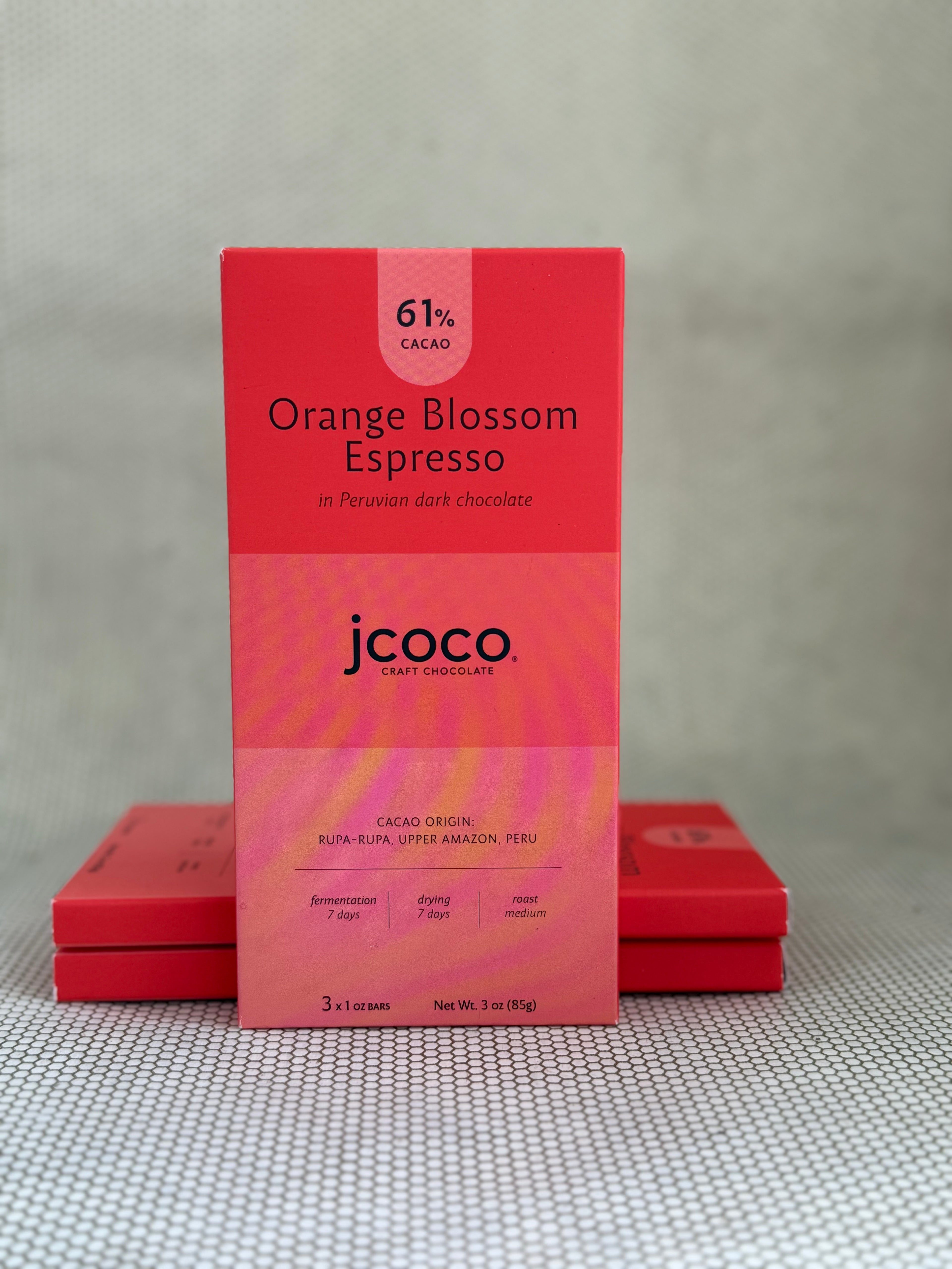 red dark chocolate bar packaging with jcoco branding on neutral background. 