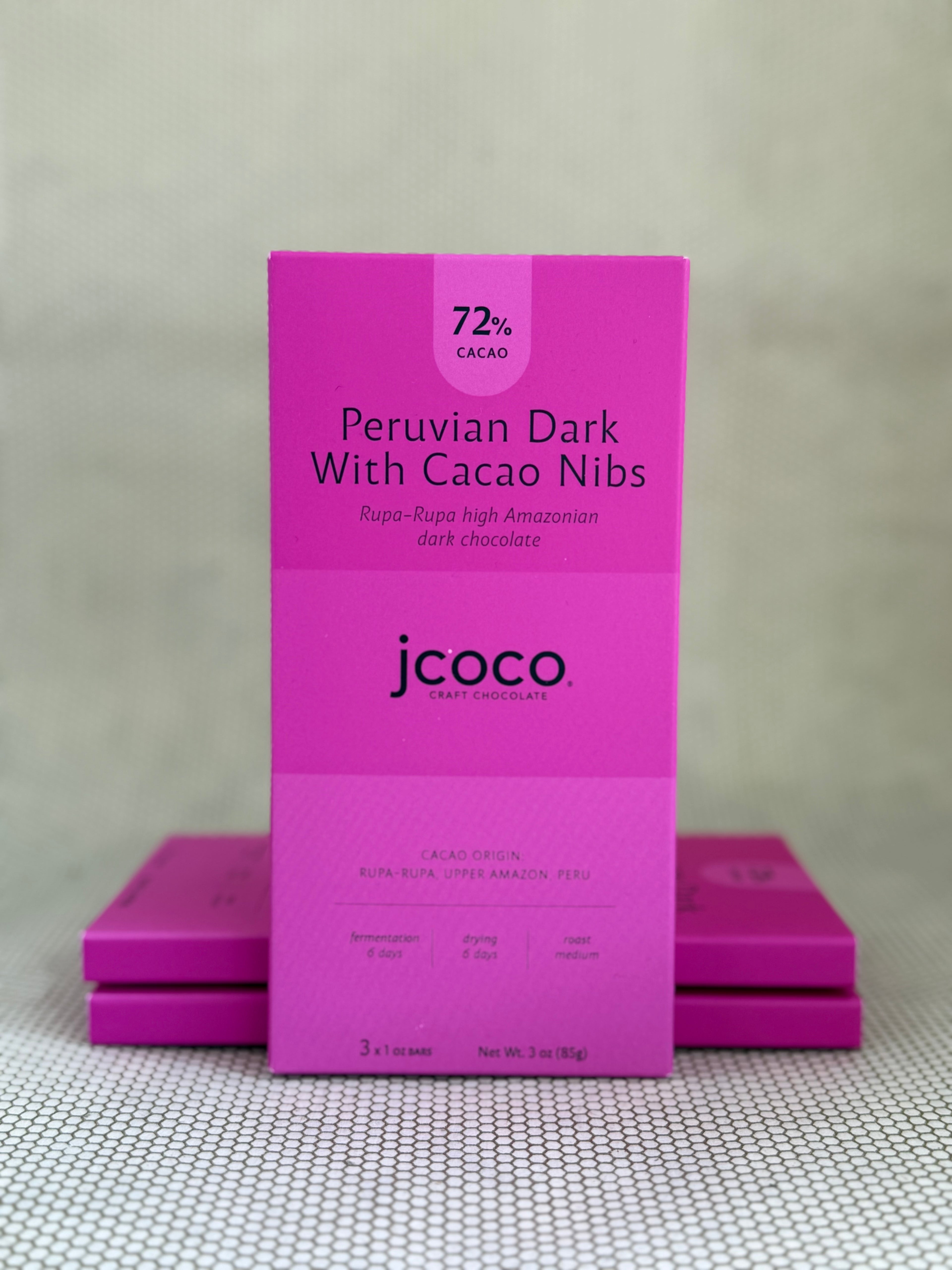 pink dark chocolate bar packaging with jcoco branding on neutral background. 