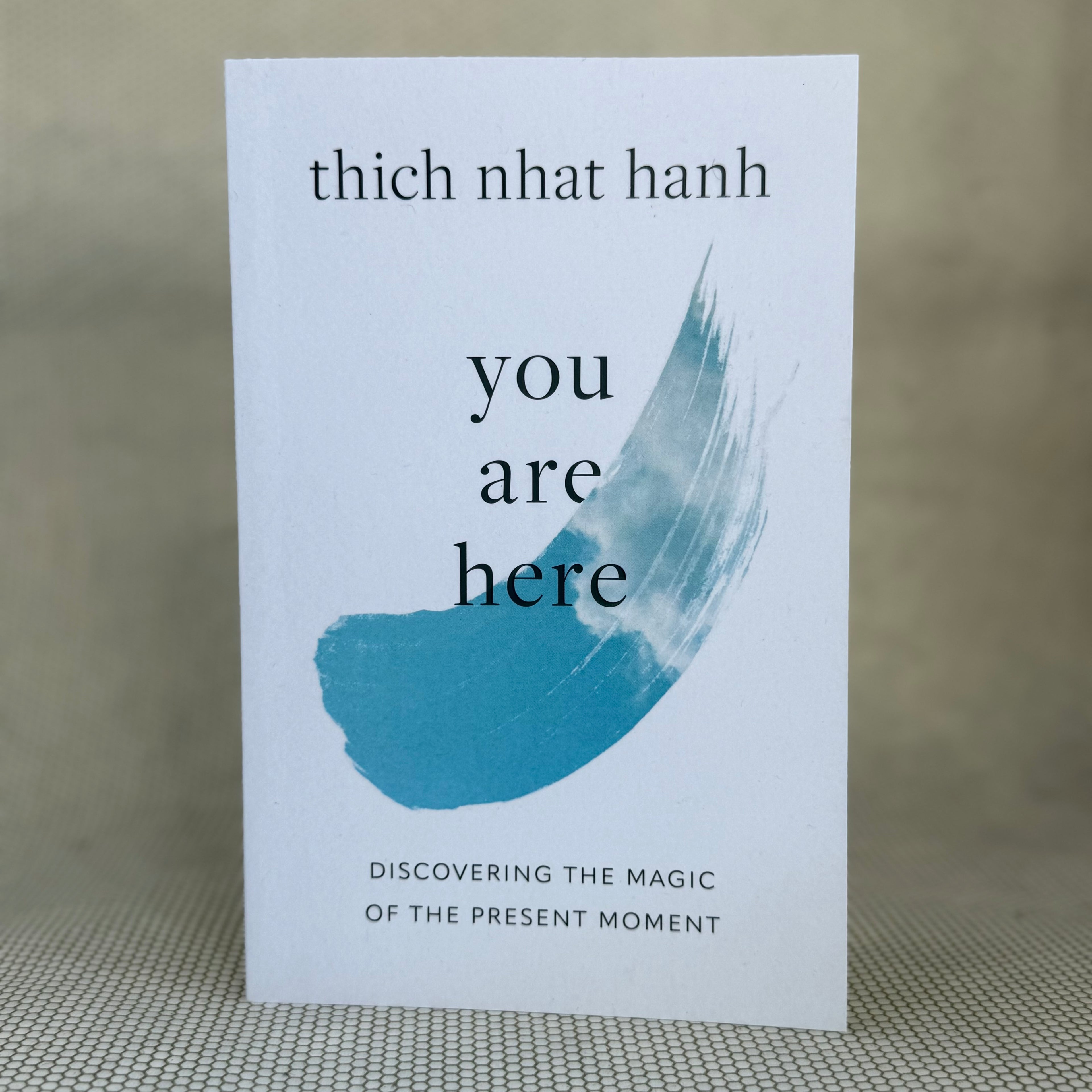 Book cover of 'You Are Here' by Thich Nhat Hanh on a textured surface.