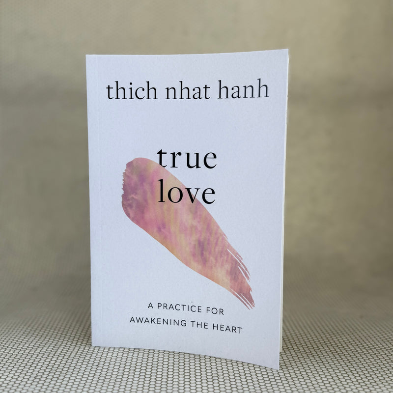 Book titled 'True Love' by Thich Nhat Hanh on a textured surface with a neutral background