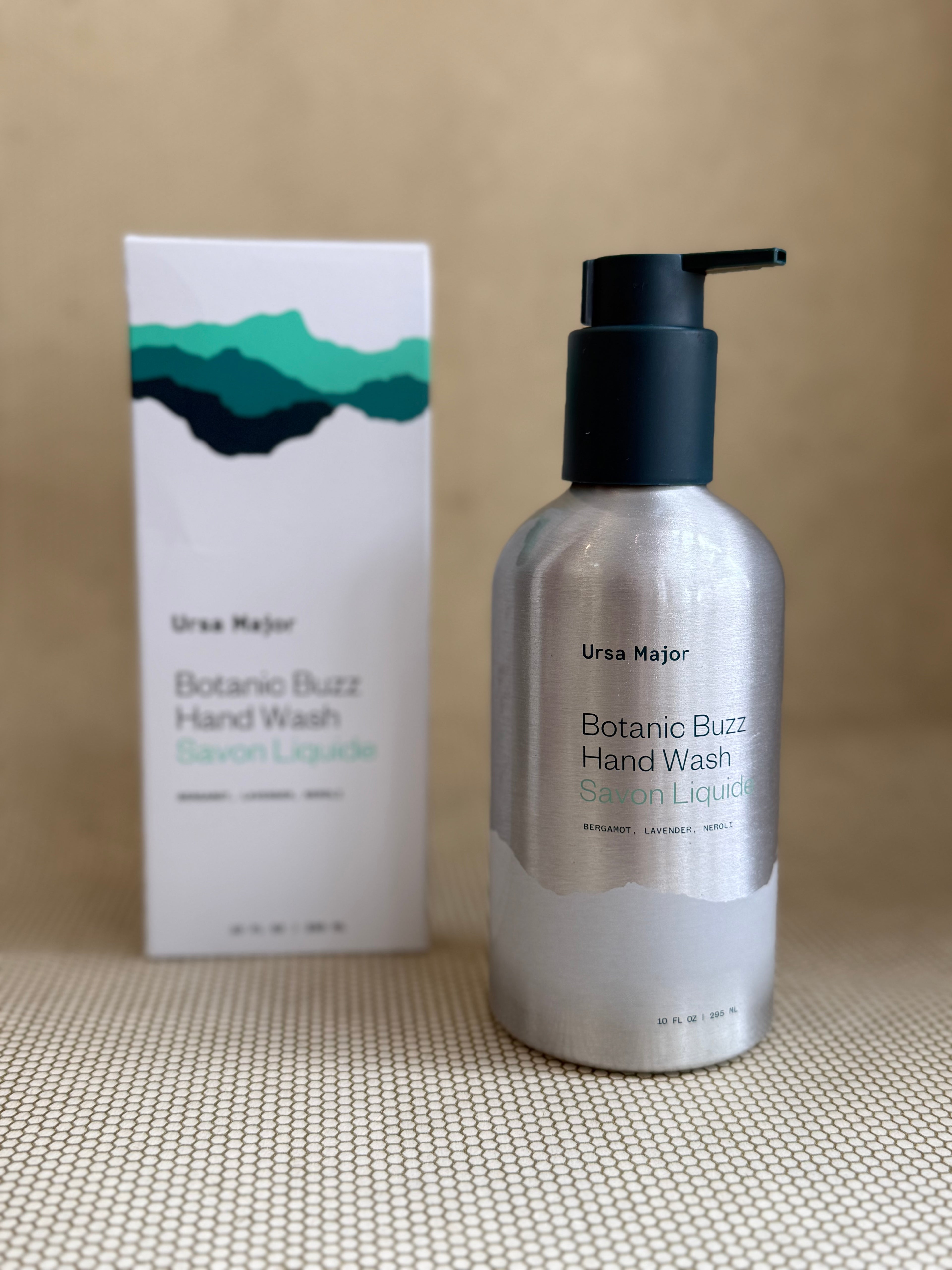 Ursa Major Botanic Buzz Hand Wash bottle and packaging on a beige background