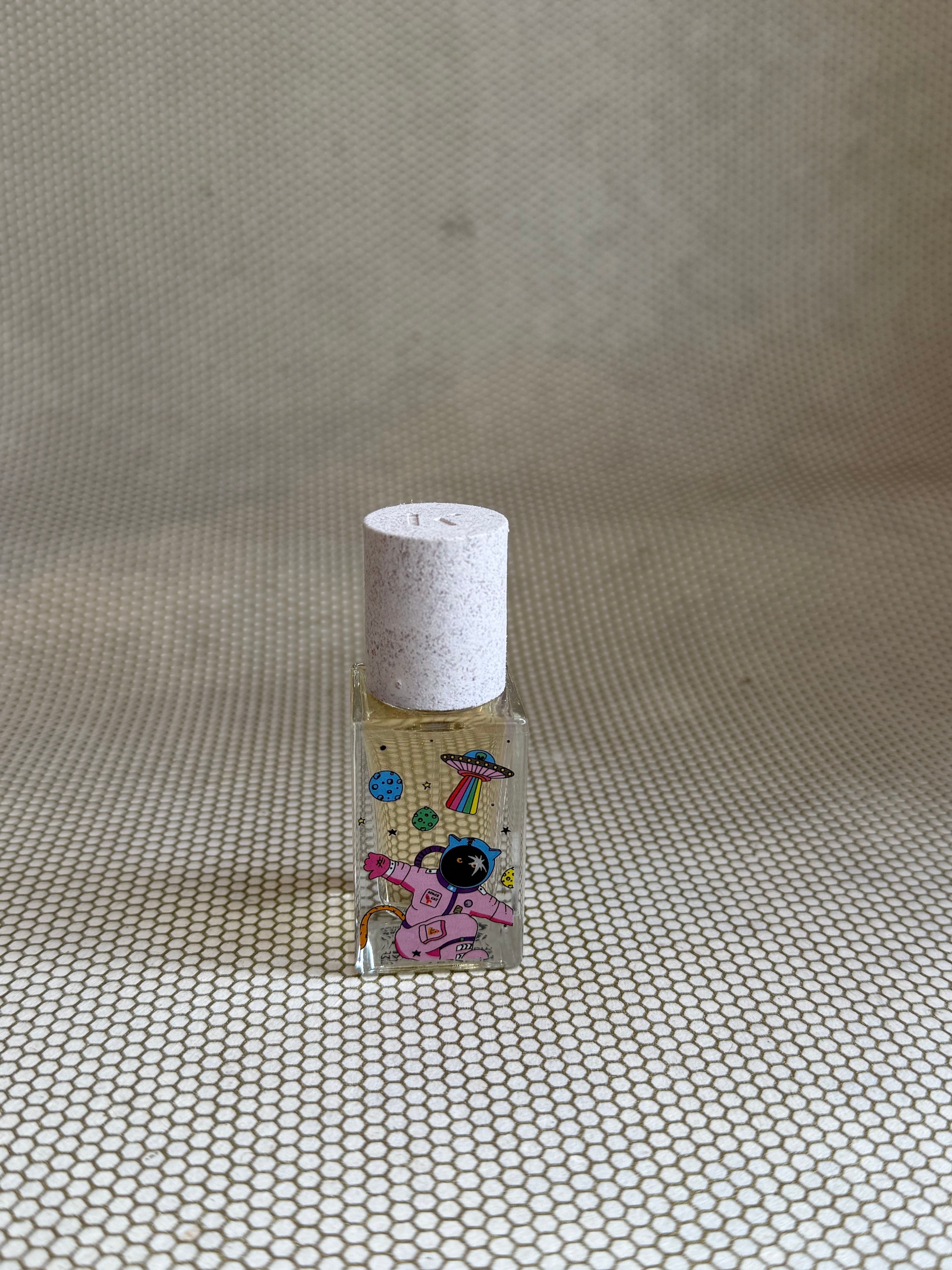 Maison Matine perfume with pink astronaut picture on glass bottle. 