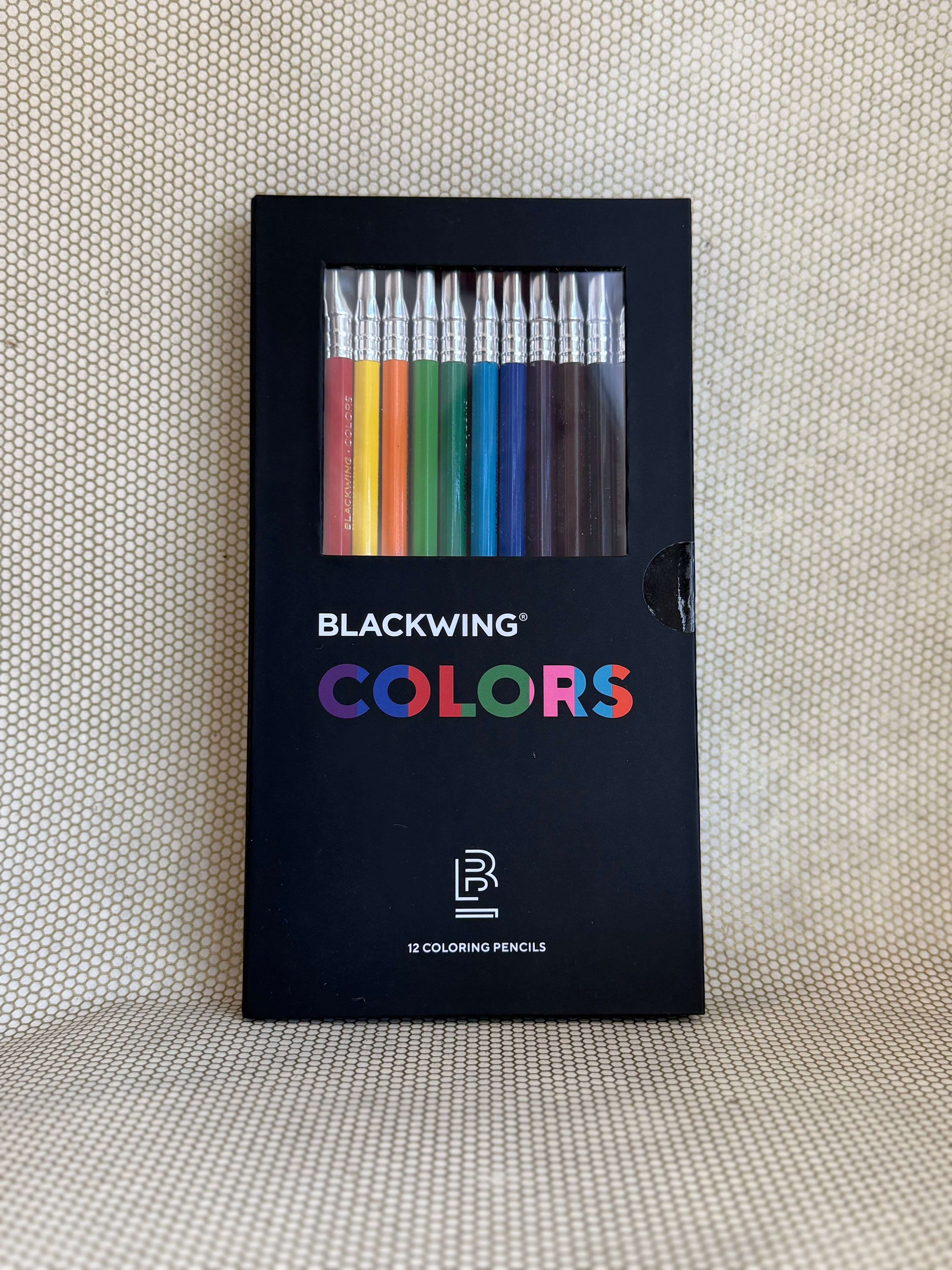 Blackwing Colors coloring pencils set in a black packaging on a textured beige background
