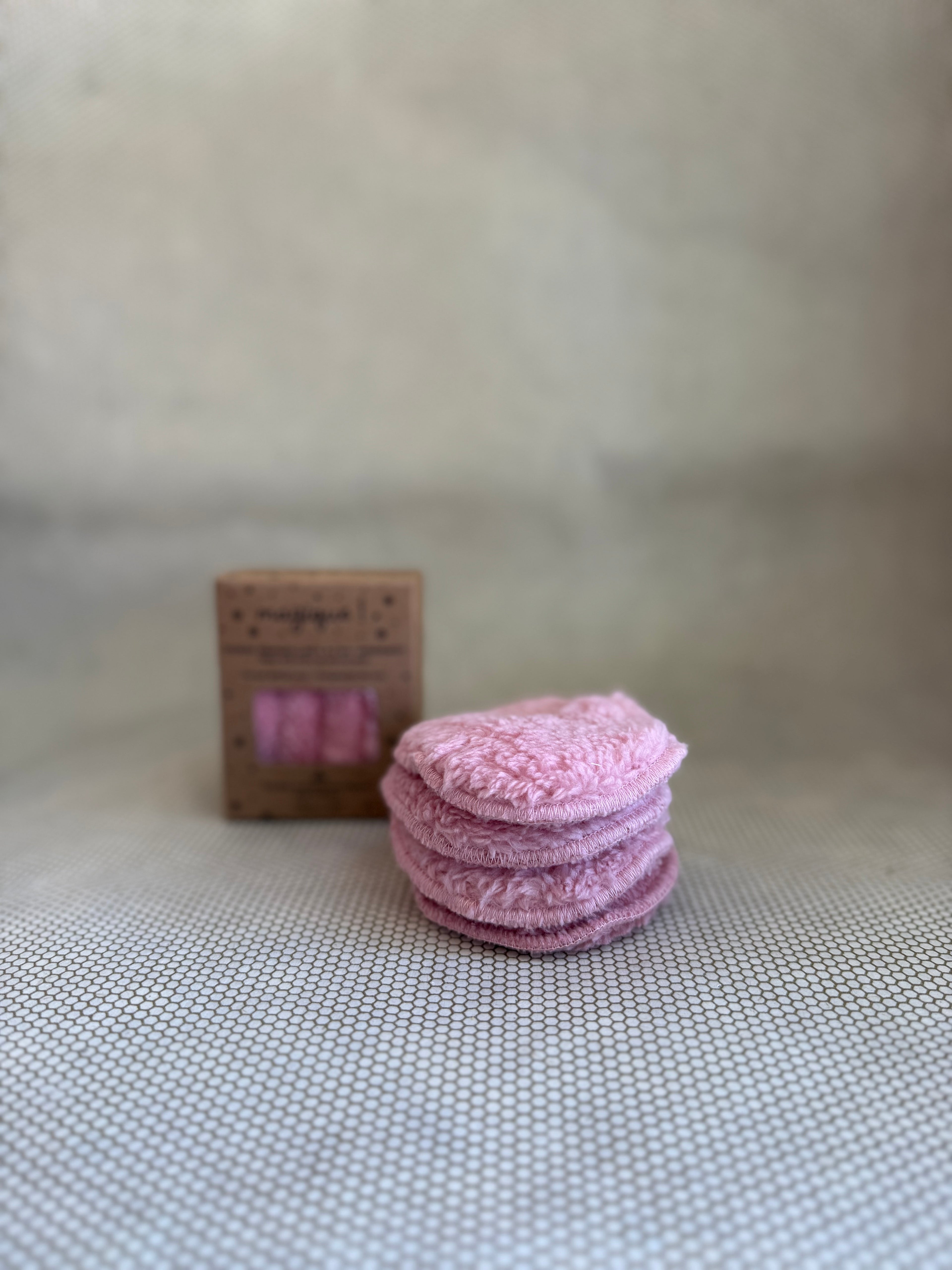 stack of Malou et Marius pink fluffy eye makeup remover pads and cardboard packaging in background. 
