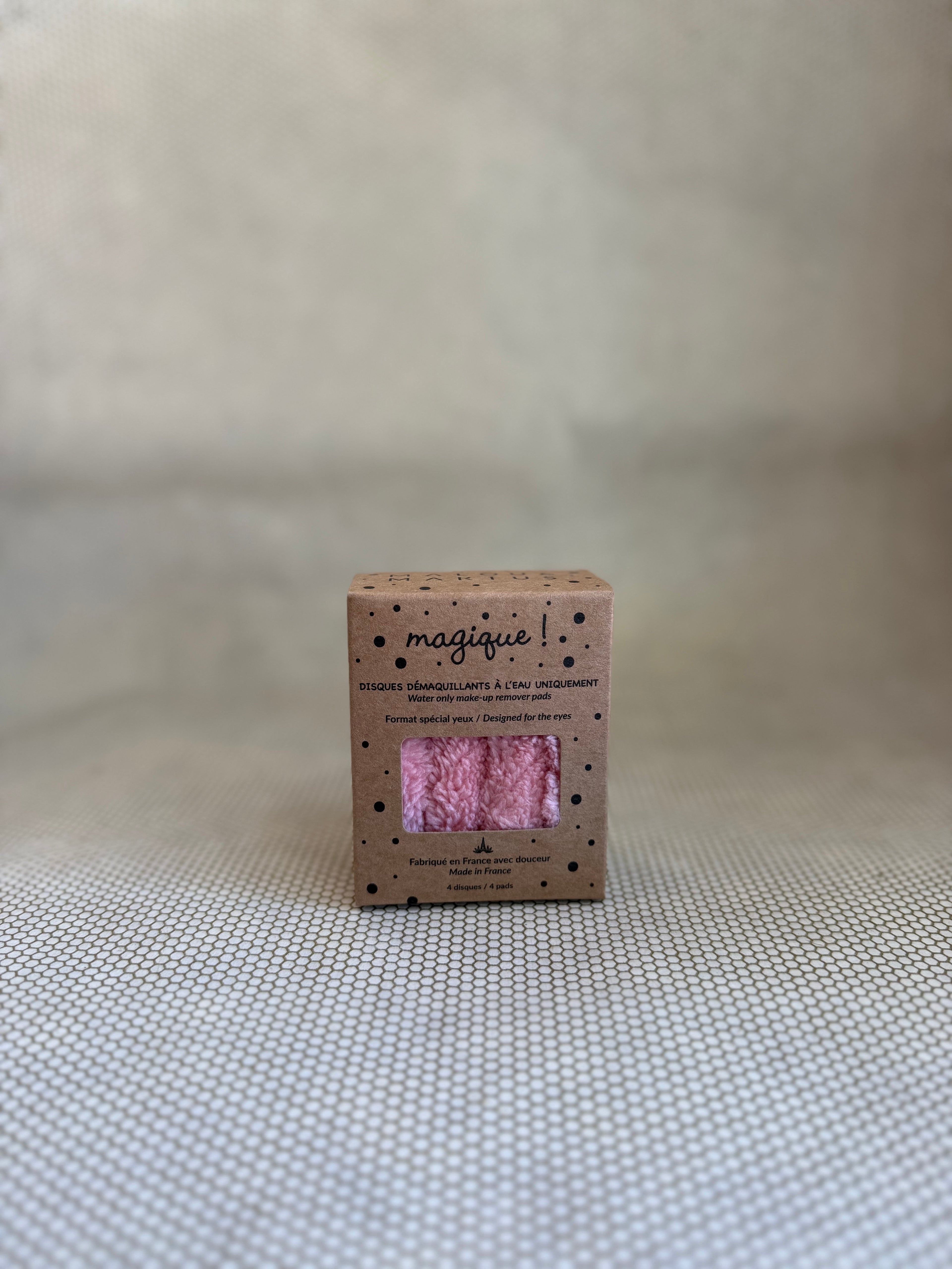 small cardboard box with pink eye makeup remover pads. 