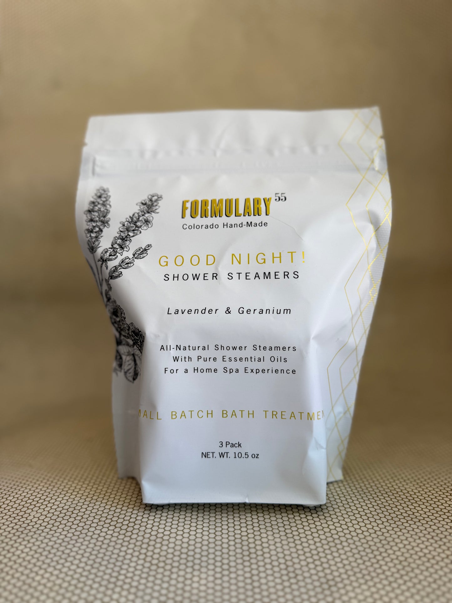 Bag of Formulary 55 good night lavender and geranium shower steamers in white bag with gold lettering and black floral graphic. 