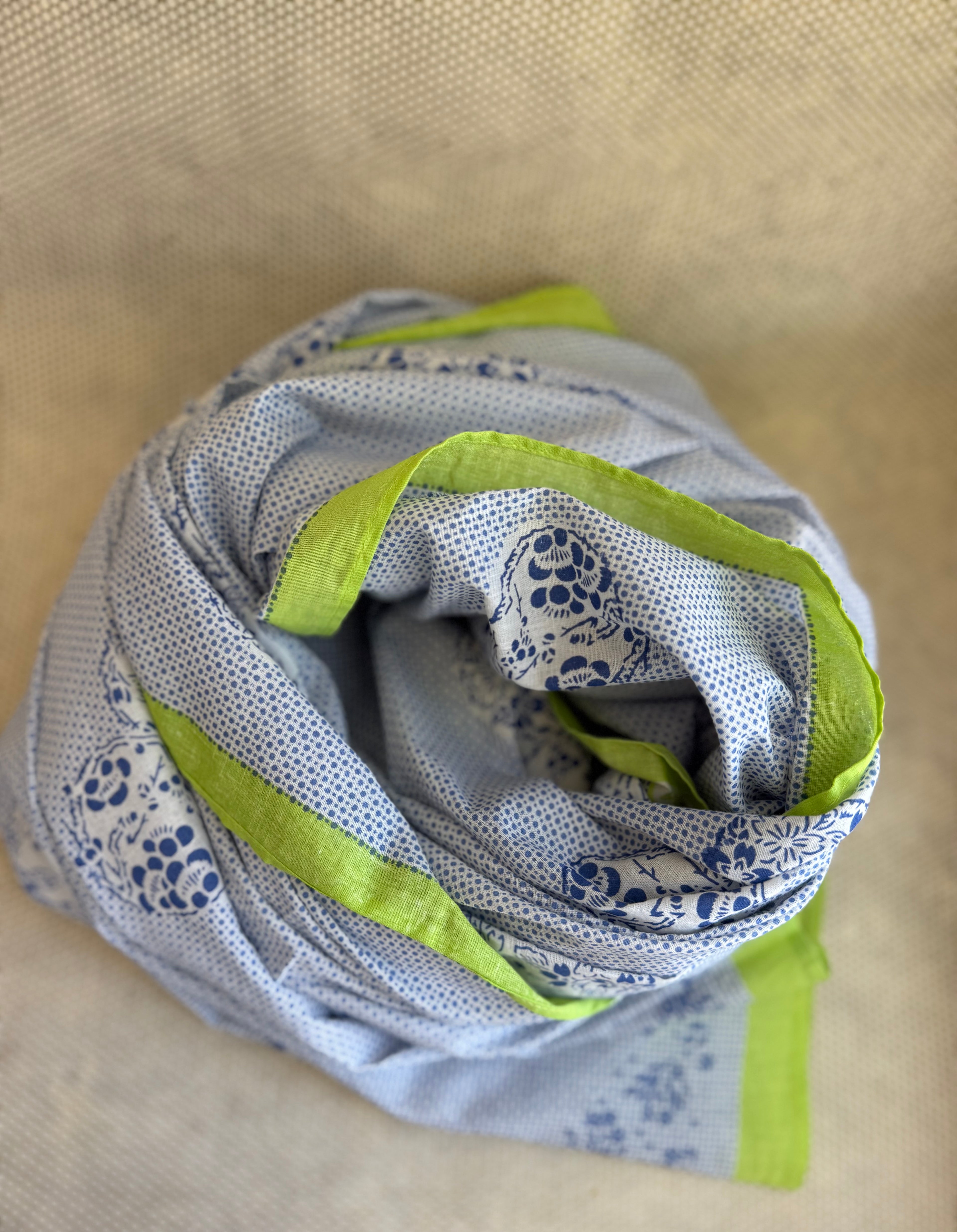 bunched lightweight scarf with green and blue design. 