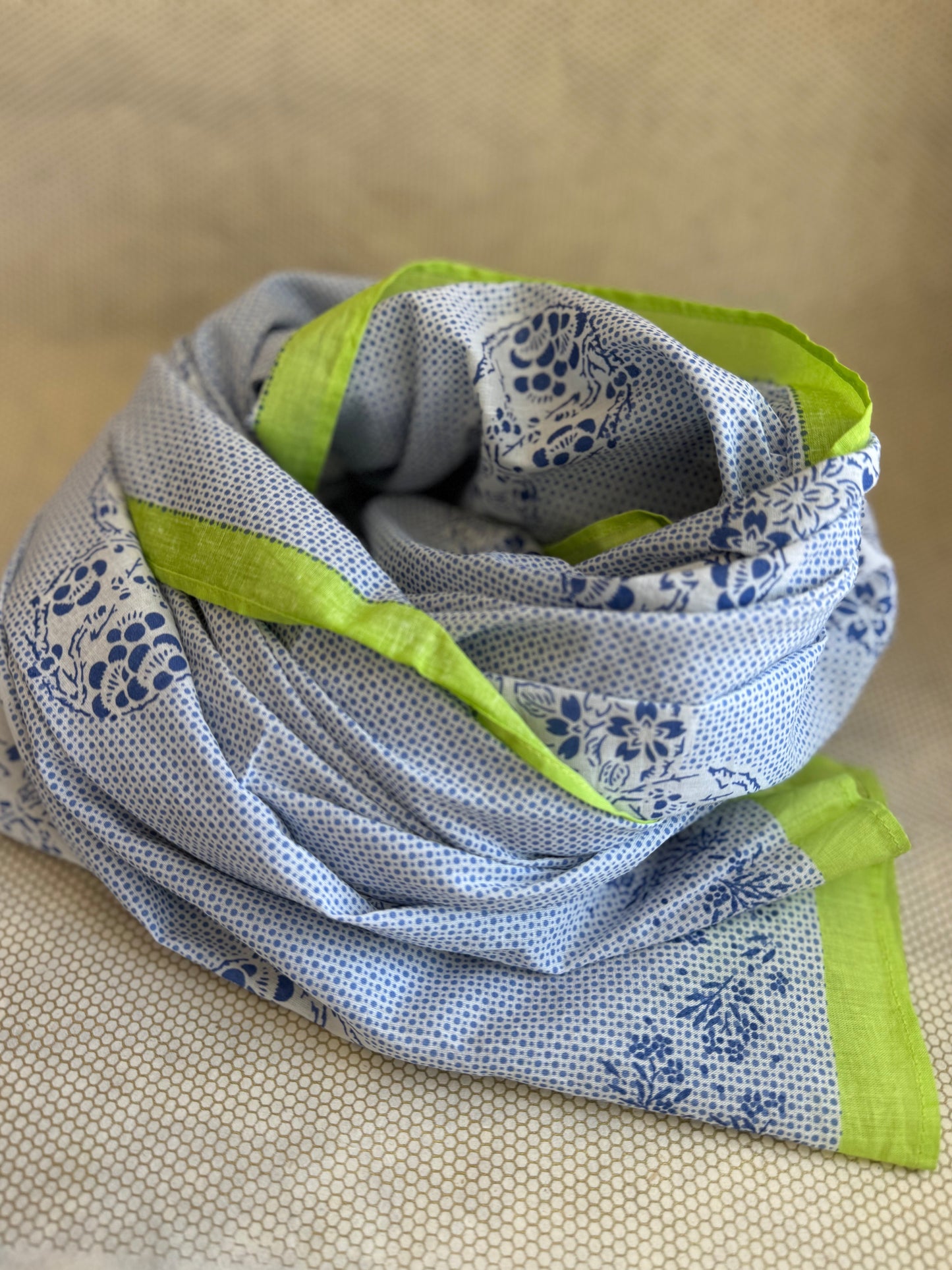 bunched lightweight scarf with green and blue design. 