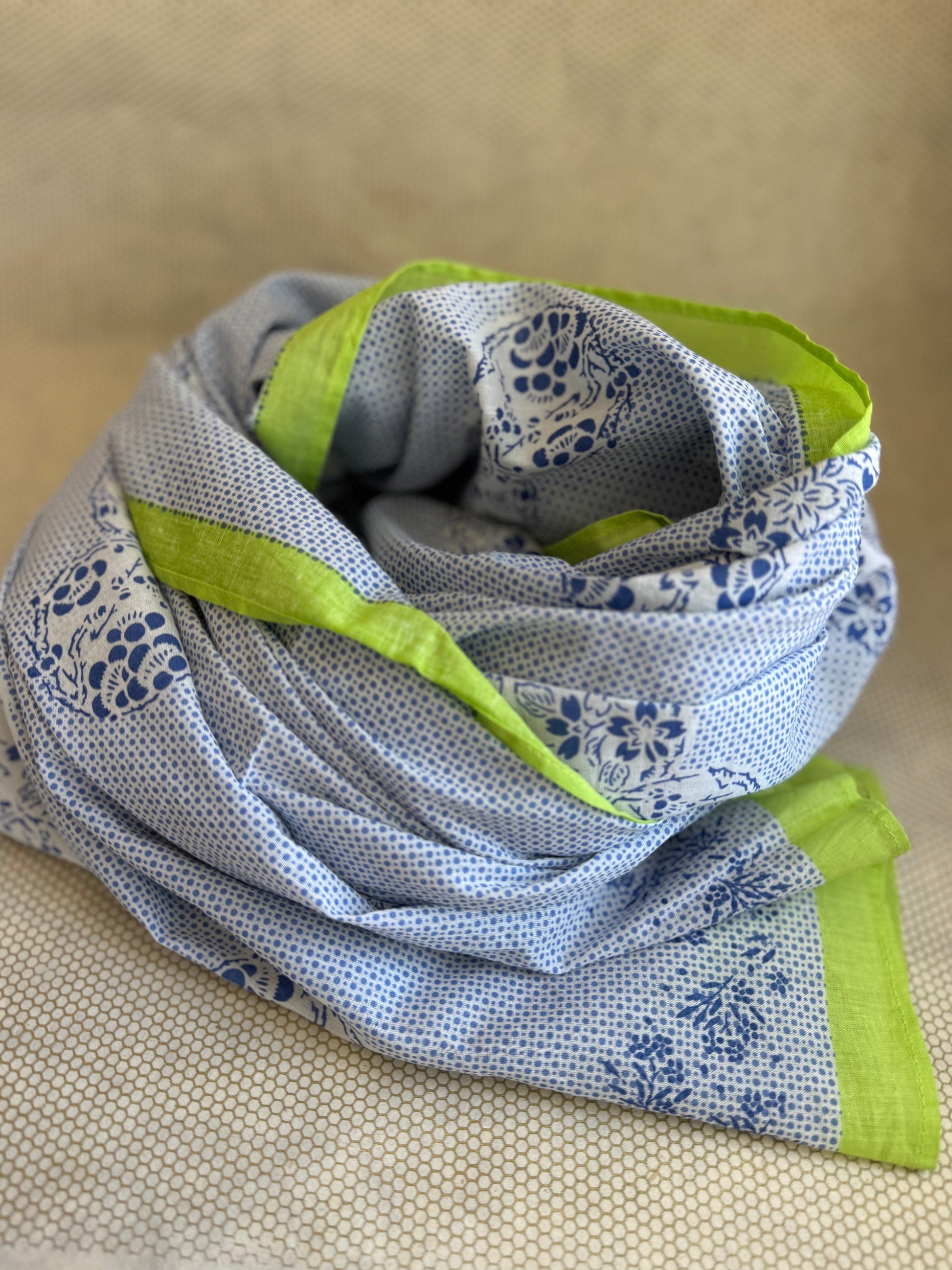 bunched lightweight scarf with green and blue design. 