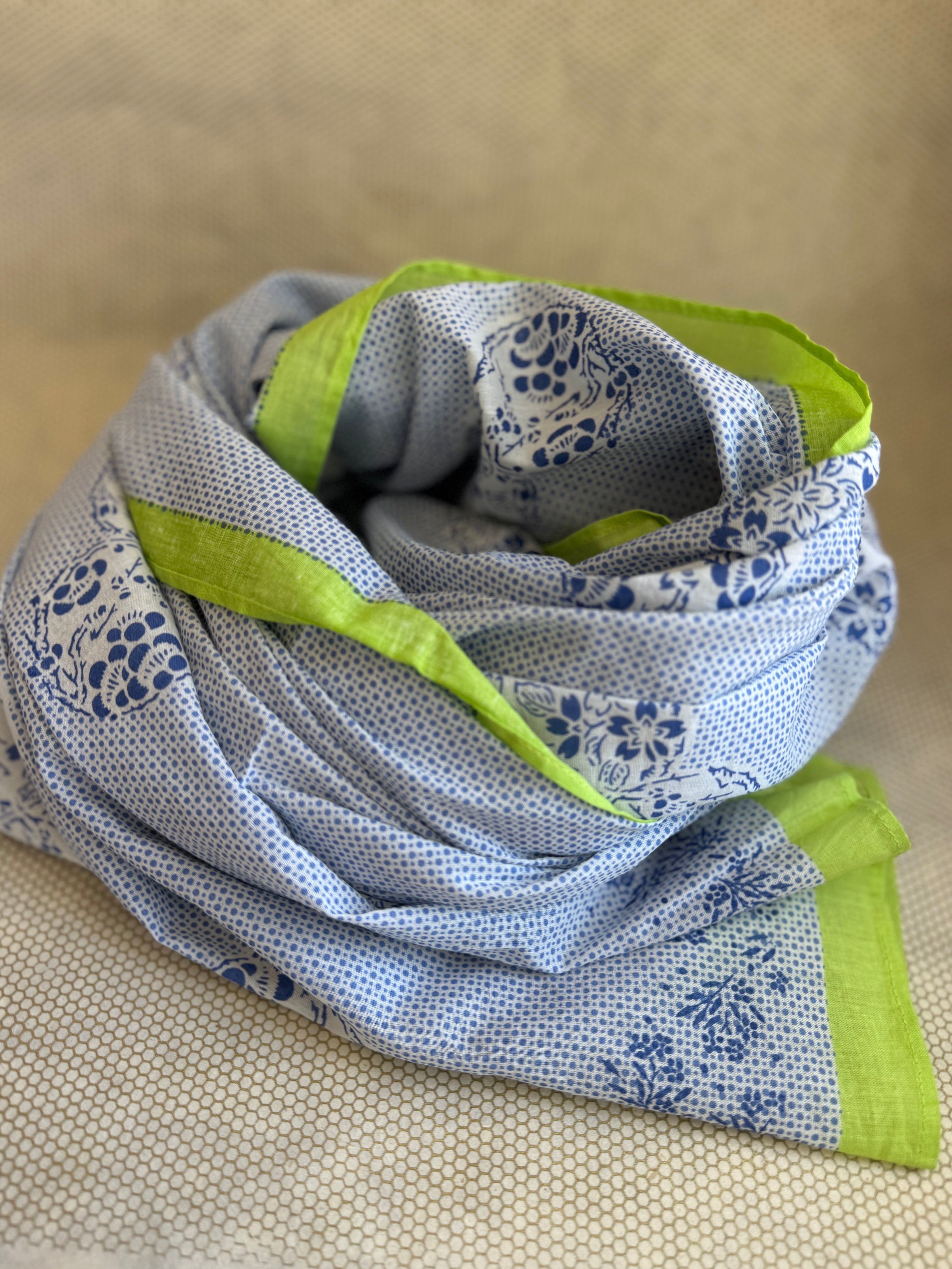 bunched lightweight scarf with green and blue design. 