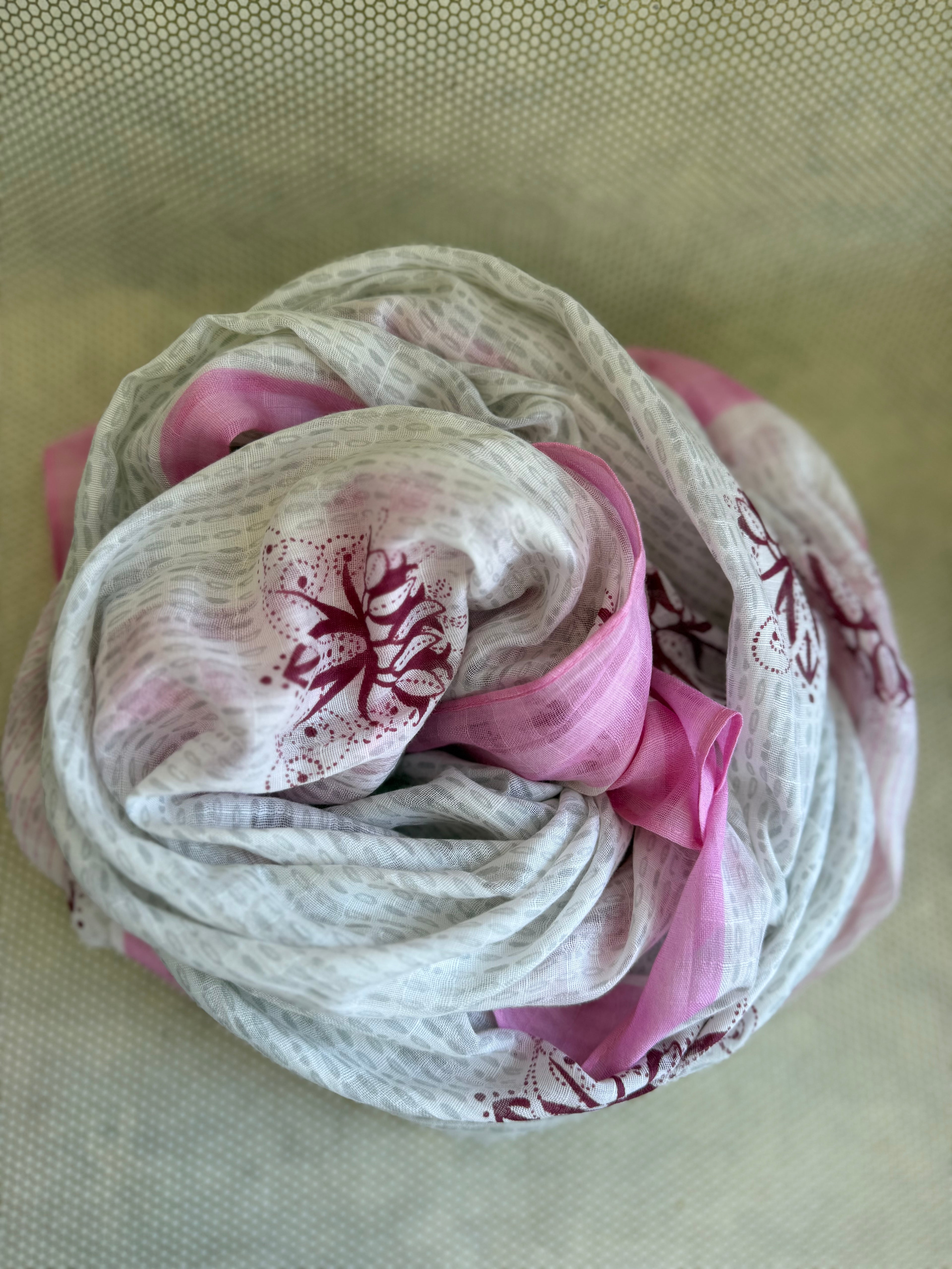 bunched lightweight scarf with pink, white and red design. 