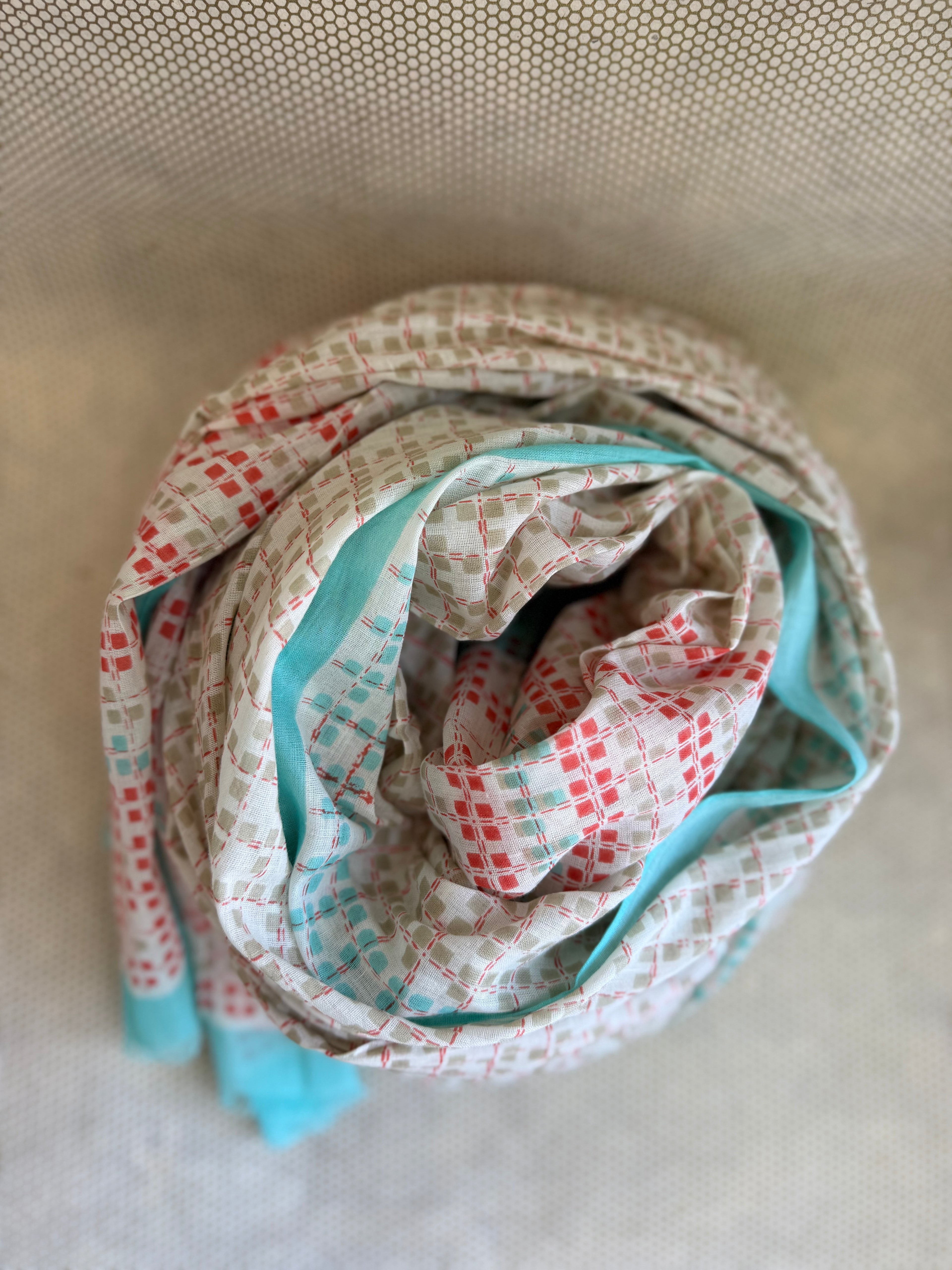 bunched lightweight scarf with red and blue design. 