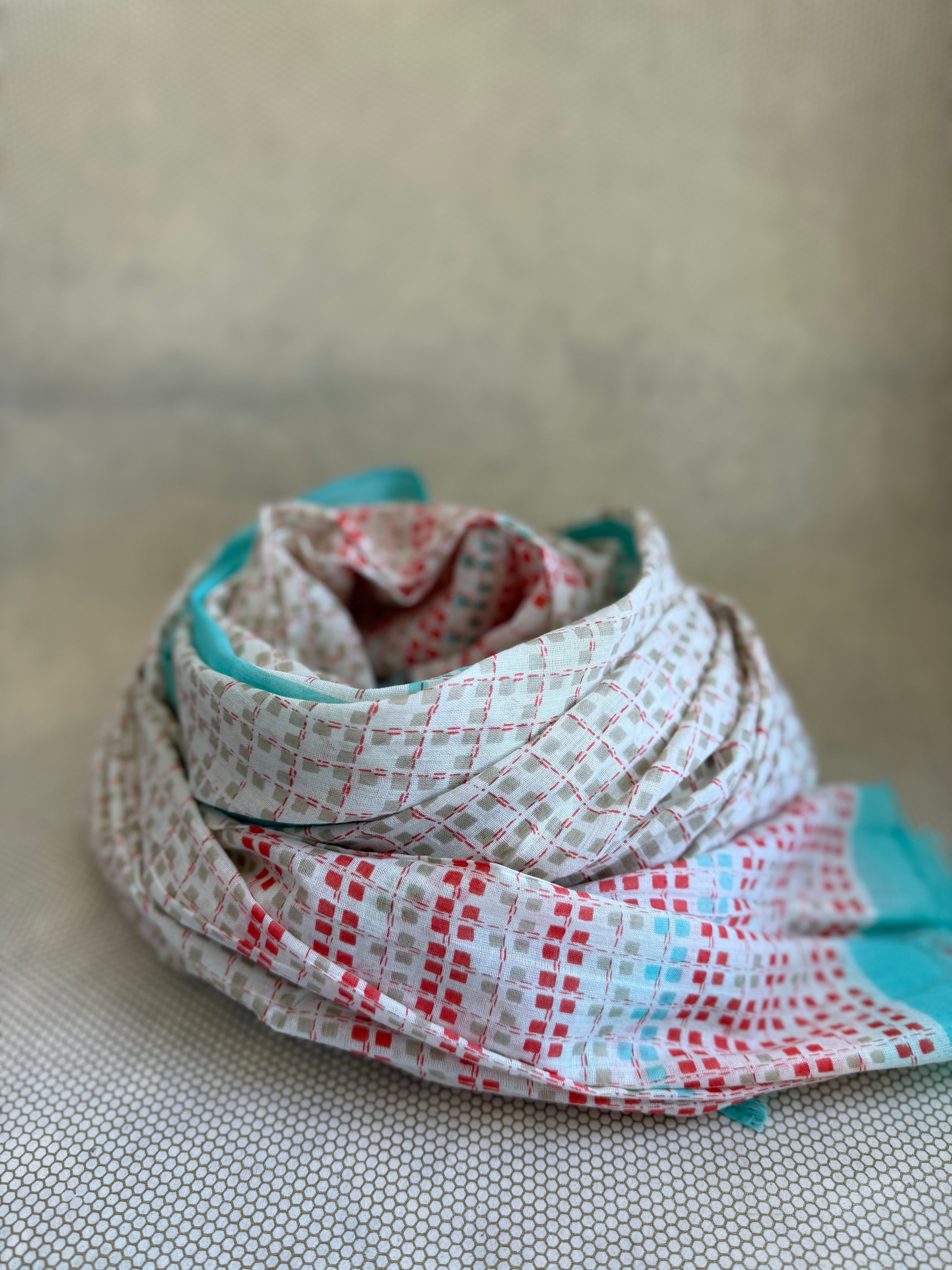 bunched lightweight scarf with red and blue design. 