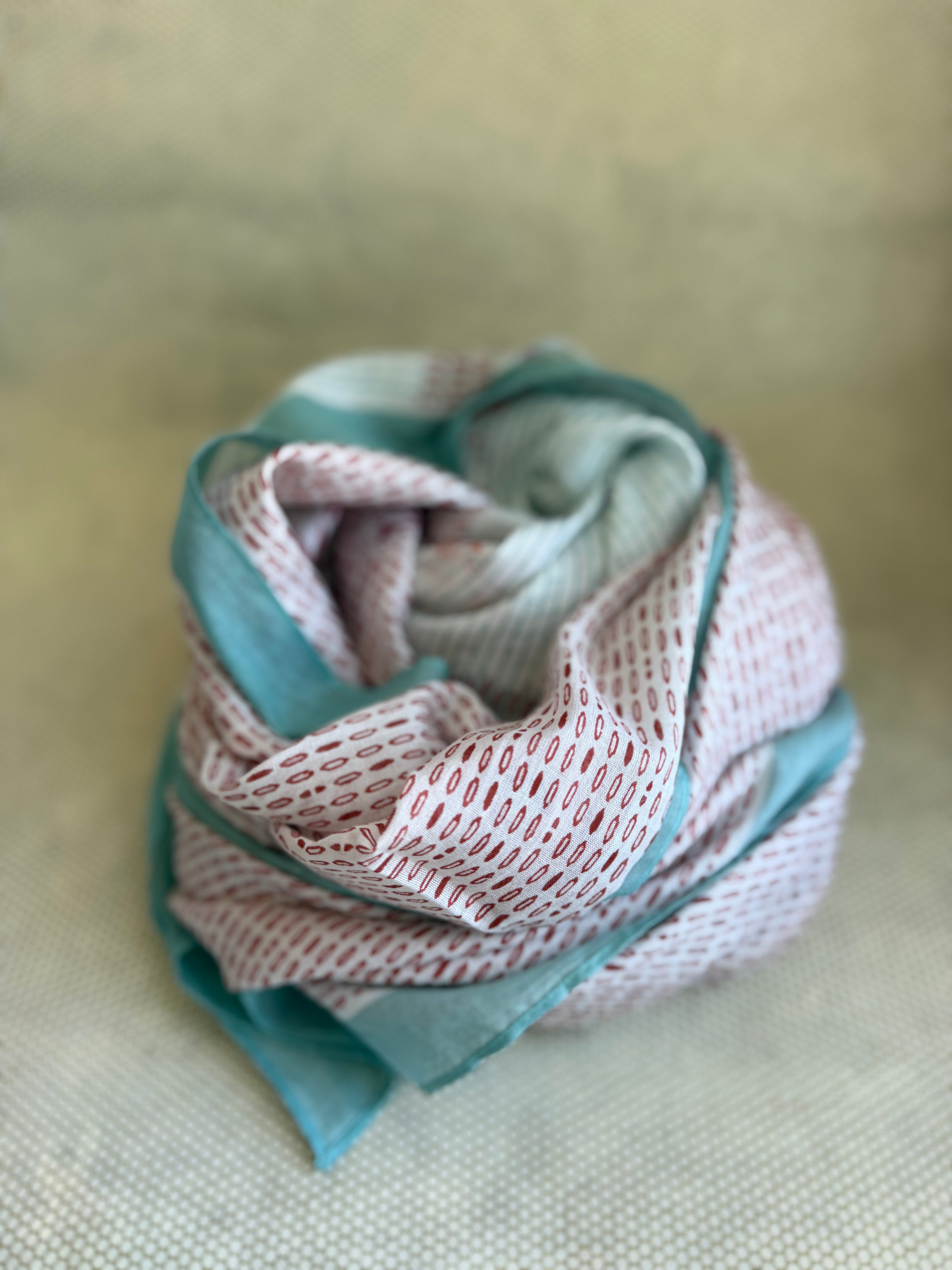 bunched lightweight scarf with red and blue design. 