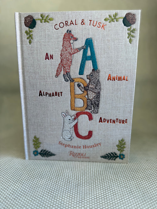 Book titled 'An Alphabet Animal Adventure' by Stephanie Housley with animal illustrations on a textured surface.