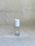 small glass bottle of maison matine perfume with hand drawing design on bottle. 